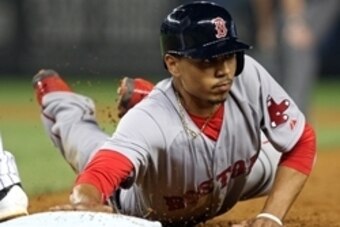 Jun 29, 2014; Bronx, NY, USA; Boston Red Sox right fielder Mookie Betts (50) dives back to first base against the New York Yankees during the sixth inning at Yankee Stadium. Tonights game is Betts MLB debut. Mandatory Credit: Adam Hunger-USA TODAY Sports