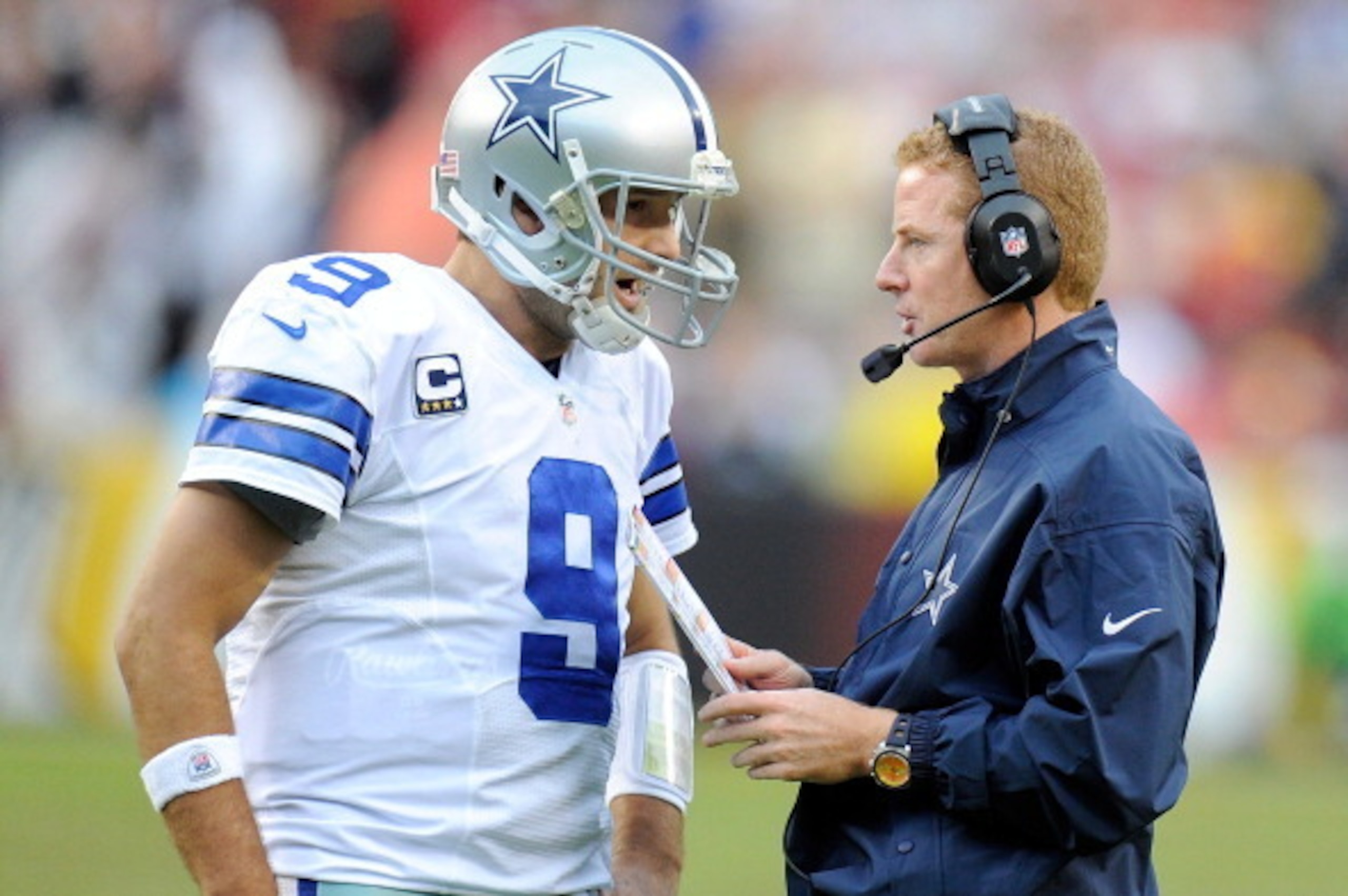 LANDOVER, MD - DECEMBER 22:  Head coach Jason Garrett of the Dallas Cowboys talks with Tony Romo #9 during a timeout in the fourth quarter against the Washington Redskins at FedExField on December 22, 2013 in Landover, Maryland. Dallas won the game 24-23.