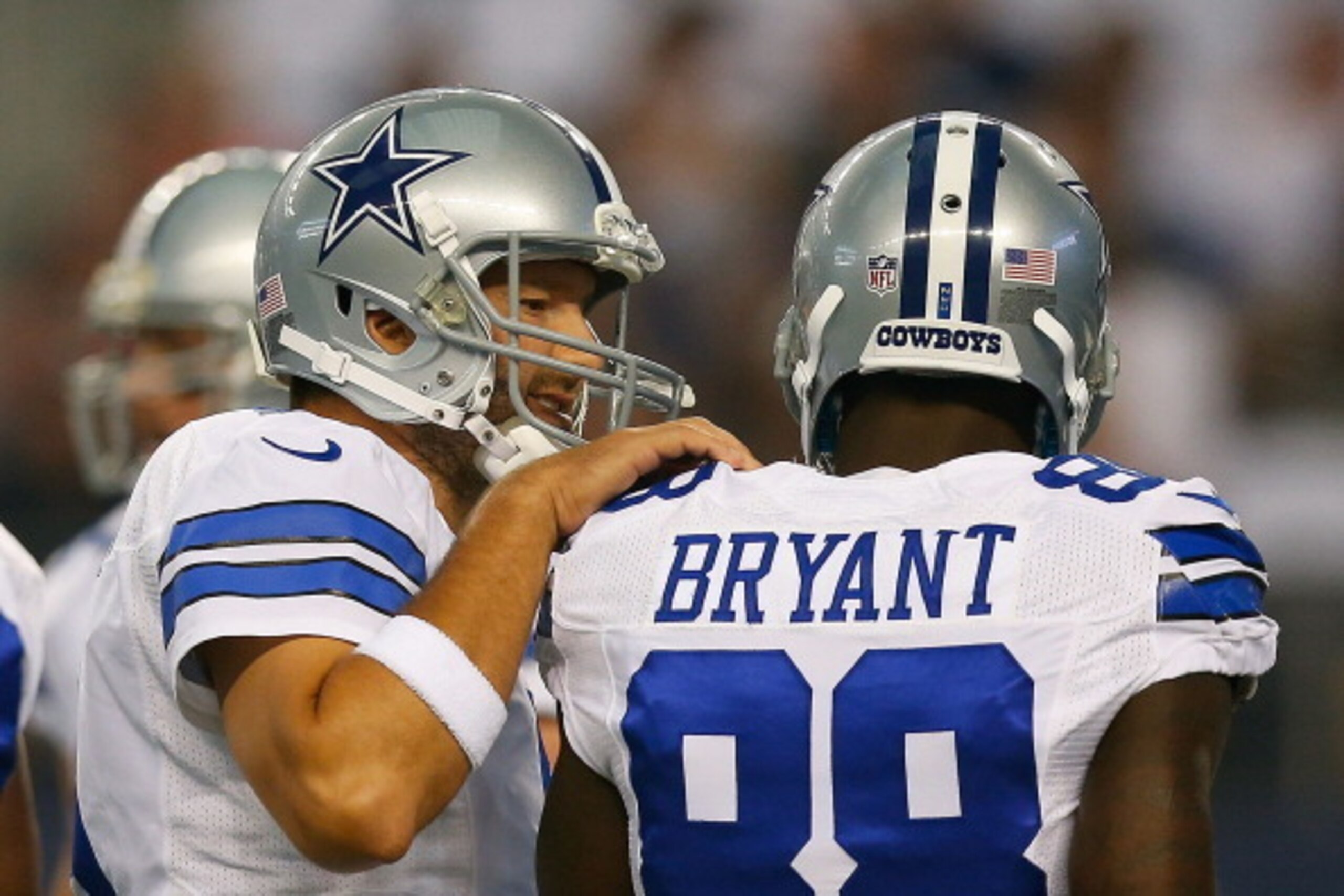ARLINGTON, TX - AUGUST 16:  Tony Romo #9 of the Dallas Cowboys talks with Dez Bryant #88 of the Dallas Cowboys between plays against the Baltimore Ravens in the first half of their preseason game at AT&T Stadium on August 16, 2014 in Arlington, Texas.  (P
