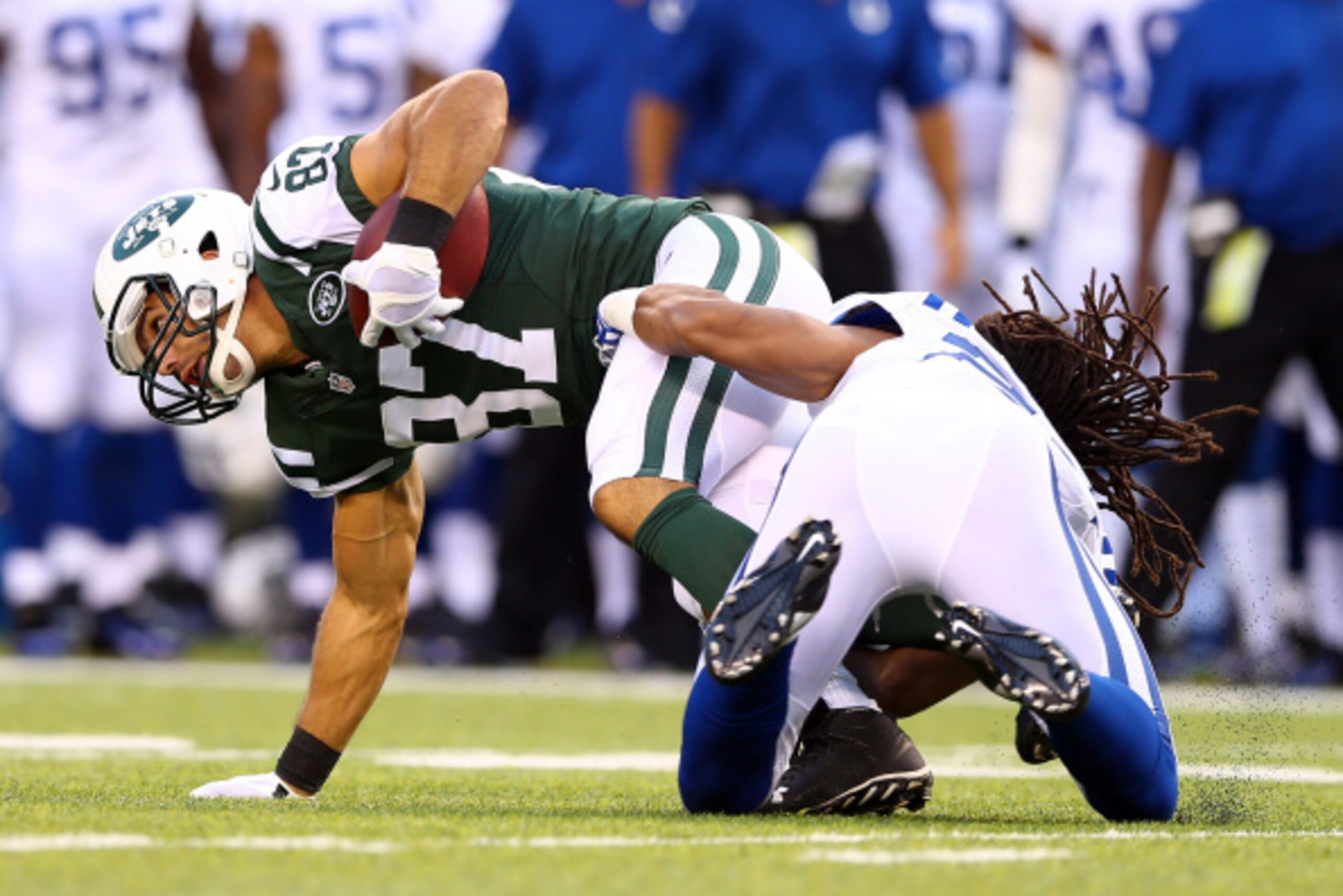 EAST RUTHERFORD, NJ - AUGUST 07: Wide receiver Eric Decker #87 of the New York Jets is tackled by defensive back Josh Gordy #27 of the Indianapolis Colts in the first quarter during a preseason game at MetLife Stadium on August 7, 2014 in East Rutherford,