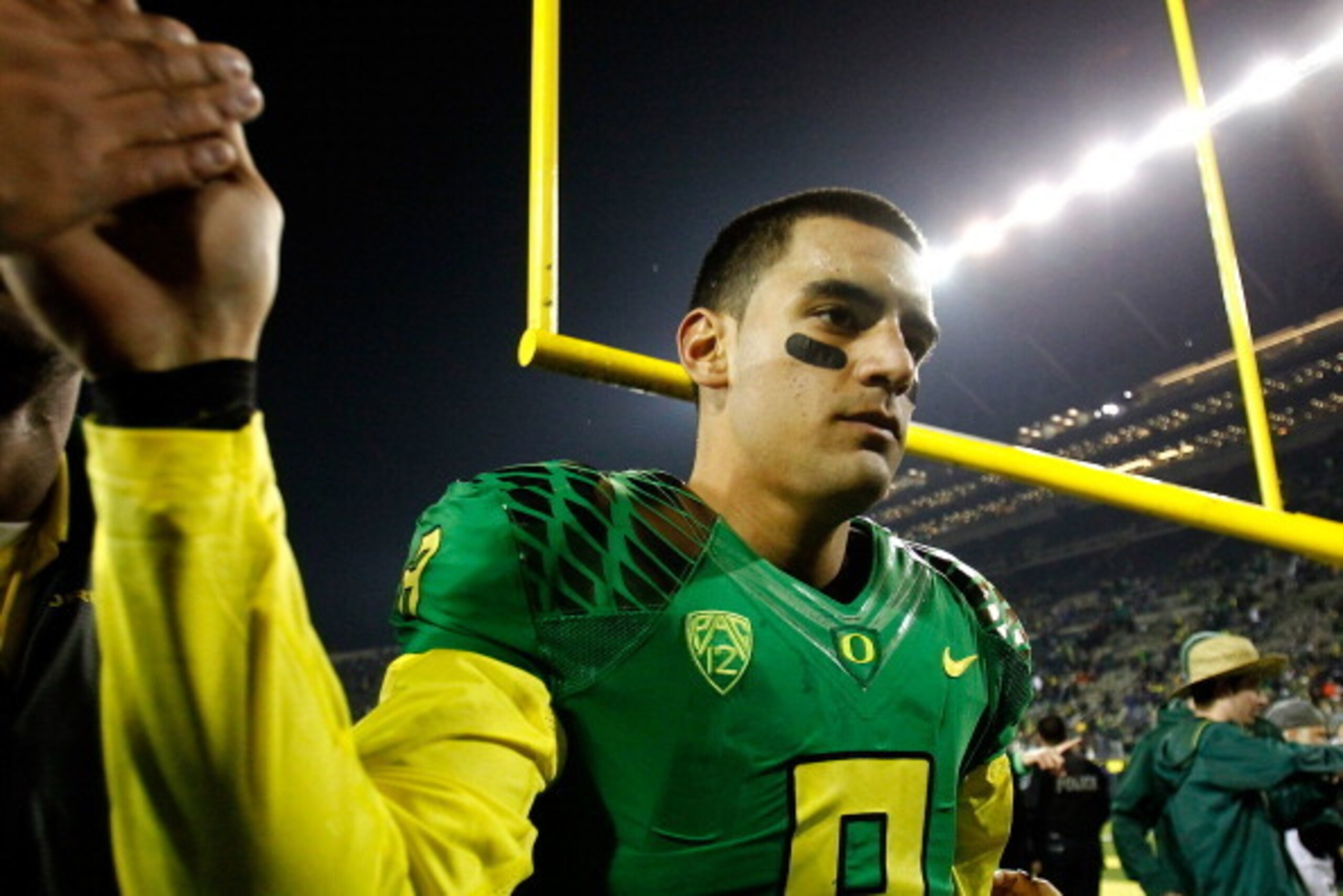 EUGENE, OR - NOVEMBER 29:  Quarterback Marcus Mariota #8 of the Oregon Ducks walks off the field after a 36-35 victory against the Oregon State Beavers during the 117th playing of the Civil War on November 29, 2013 at the Autzen Stadium in Eugene, Oregon.
