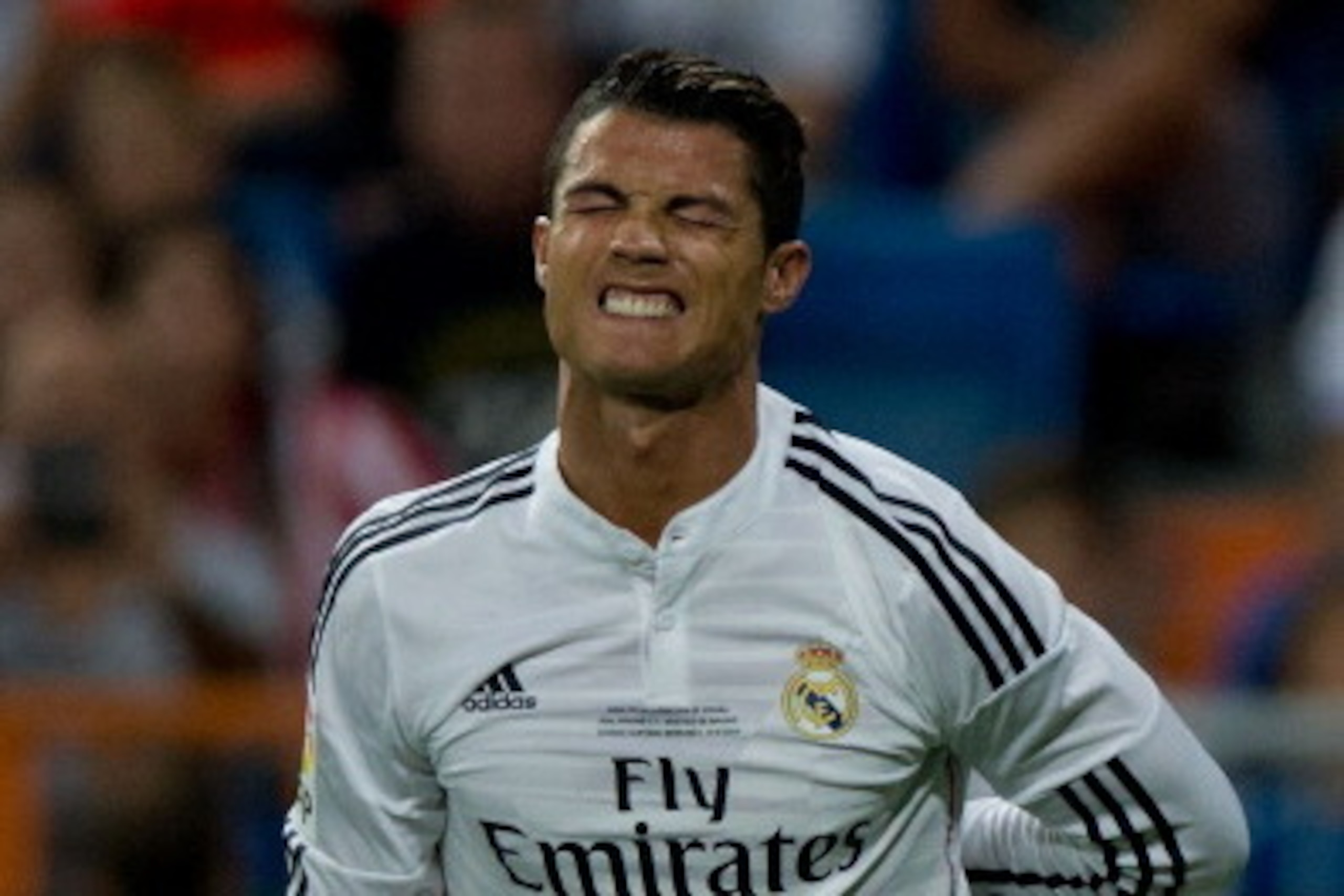 MADRID, SPAIN - AUGUST 19:  Cristiano Ronaldo of Real Madrid CF grimaces in pain during the Supercopa first leg match between Real Madrid and Club Atletico de Madrid at Estadio Santiago Bernabeu on August 19, 2014 in Madrid, Spain.  (Photo by Gonzalo Arro