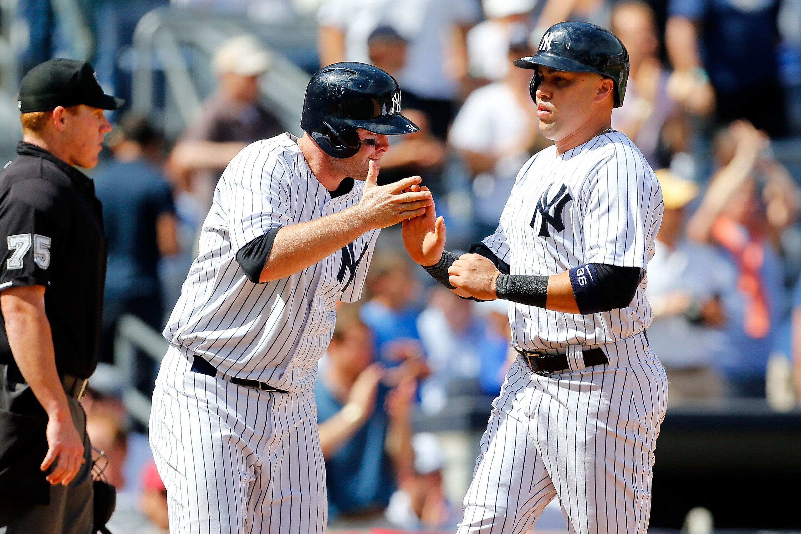 NEW YORK, NY - AUGUST 23:  Carlos Beltran #36 and Brian McCann #34 of the New York Yankees celebrate after both scored in the fourth inning against the Chicago White Sox at Yankee Stadium on August 23, 2014 in the Bronx borough of New York City.  (Photo b