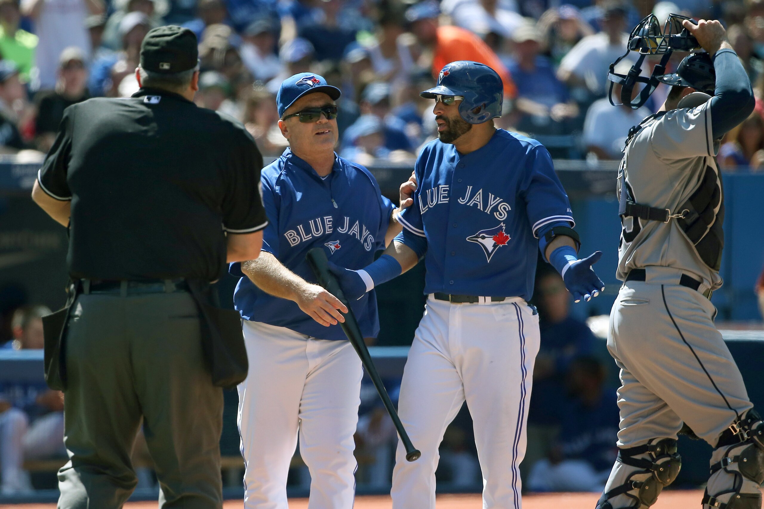 TORONTO, CANADA - AUGUST 24: Jose Bautista #19 of the Toronto Blue Jays reacts after being ejected by home plate umpire Bill Welke #52 for arguing a called third strike as manager John Gibbons #5 comes out to restrain him in the sixth inning during MLB ga