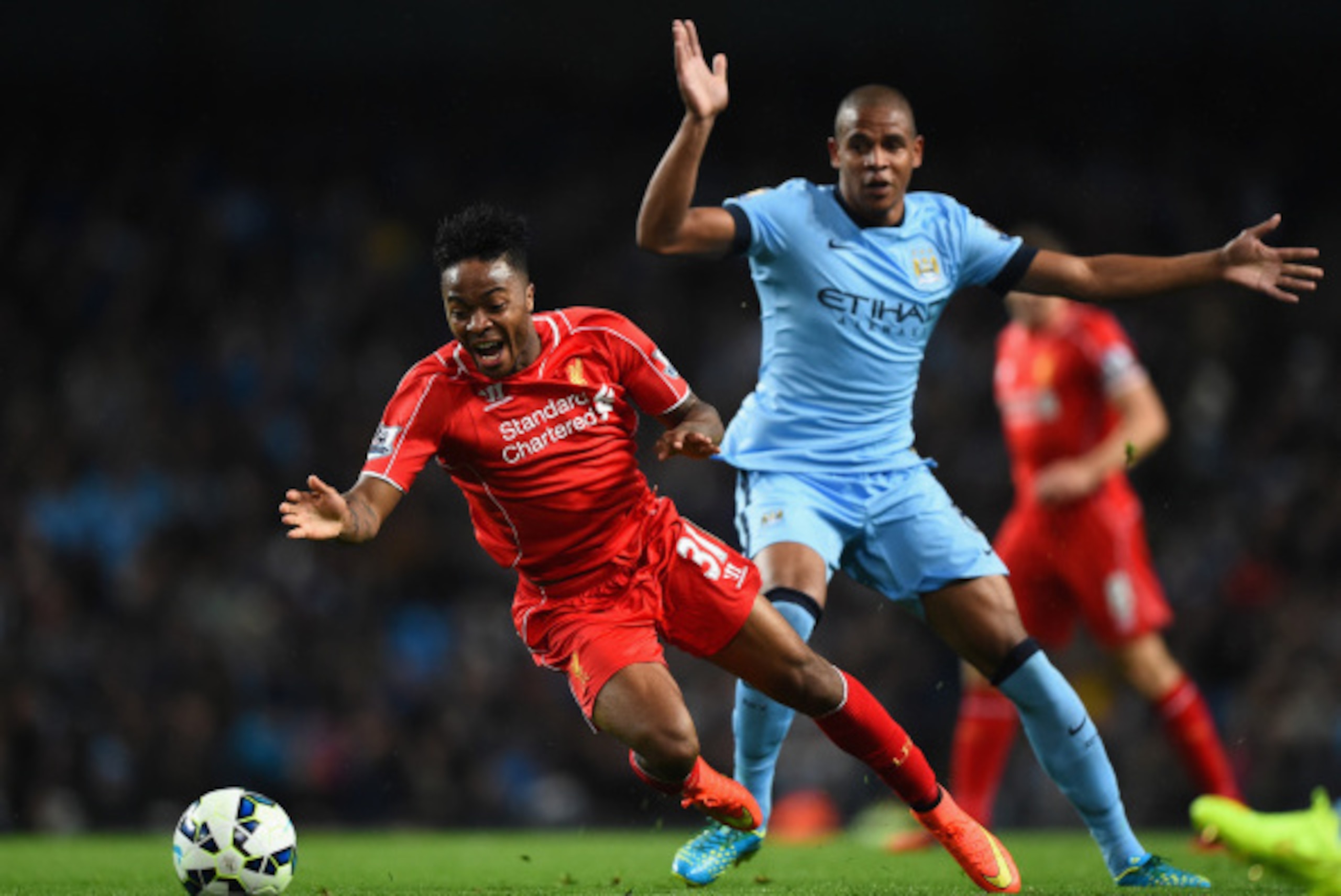MANCHESTER, ENGLAND - AUGUST 25:  Raheem Sterling of Liverpool is challenged by Fernando Reges of Manchester City during the Barclays Premier League match between Manchester City and Liverpool at the Etihad Stadium on August 25, 2014 in Manchester, Englan