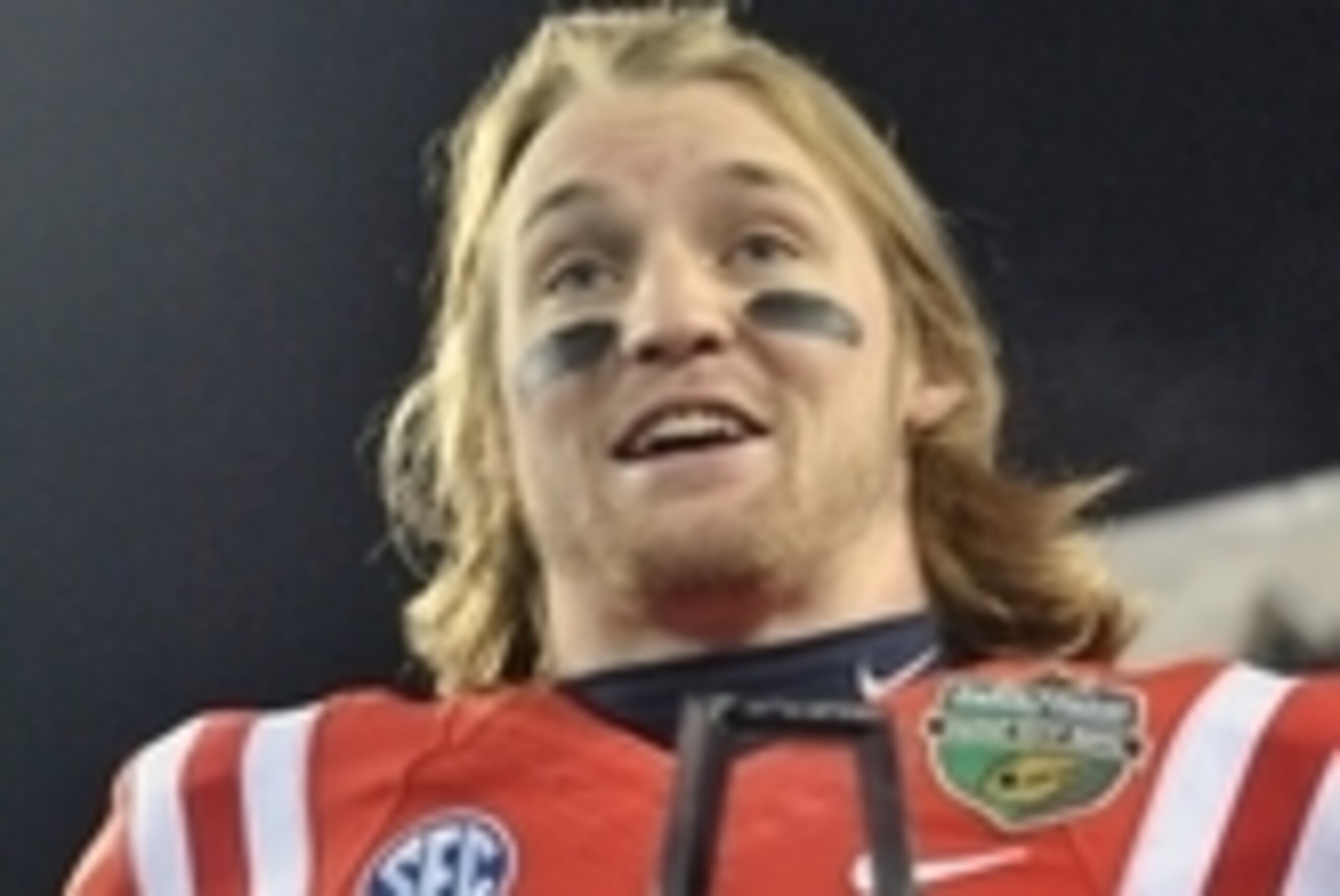 Dec 30, 2013; Nashville, TN, USA; Mississippi Rebels quarterback Bo Wallace (14) accepts the MVP trophy after defeated the Georgia Tech Yellow Jackets 25-17 at LP Field. Mandatory Credit: Jim Brown-USA TODAY Sports