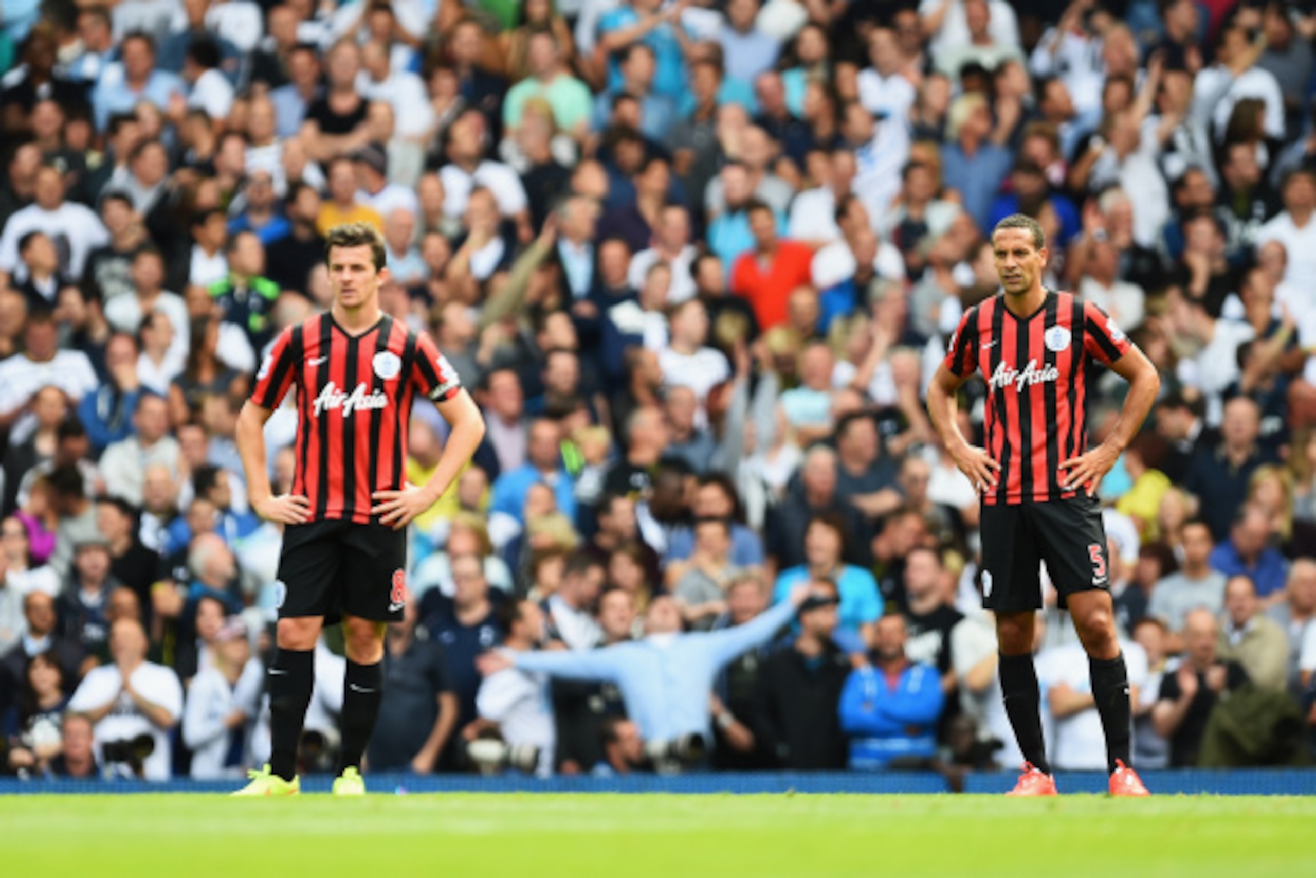 LONDON, ENGLAND - AUGUST 24: Joey Barton (L) and Rio Ferdinand of QPR look dejected after the third Spurs goal during the Barclays Premier League match between Tottenham Hotspur and Queens Park Rangers at White Hart Lane on August 24, 2014 in London, Engl