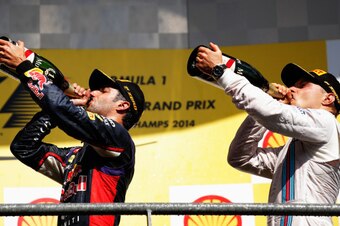 SPA, BELGIUM - AUGUST 24:  Daniel Ricciardo of Australia and Infiniti Red Bull Racing celebrates on the podium next to Valtteri Bottas of Finland and Williams after winning the Belgian Grand Prix at Circuit de Spa-Francorchamps on August 24, 2014 in Spa, 