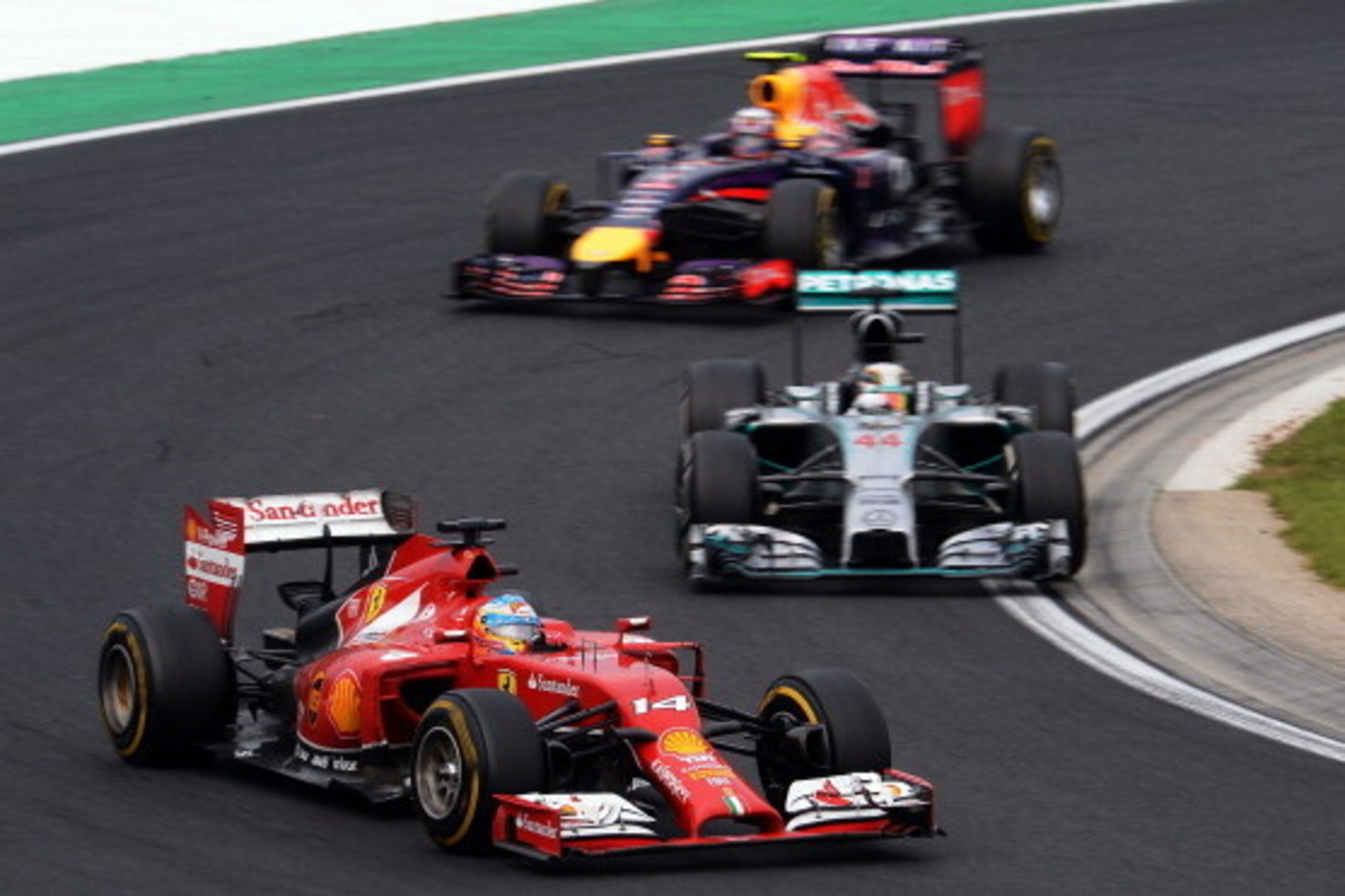 BUDAPEST, HUNGARY - JULY 27:  Fernando Alonso of Spain and Ferrari, Lewis Hamilton of Great Britain and Mercedes GP and Daniel Ricciardo of Australia and Infiniti Red Bull Racing drive during the Hungarian Formula One Grand Prix at Hungaroring on July 27,