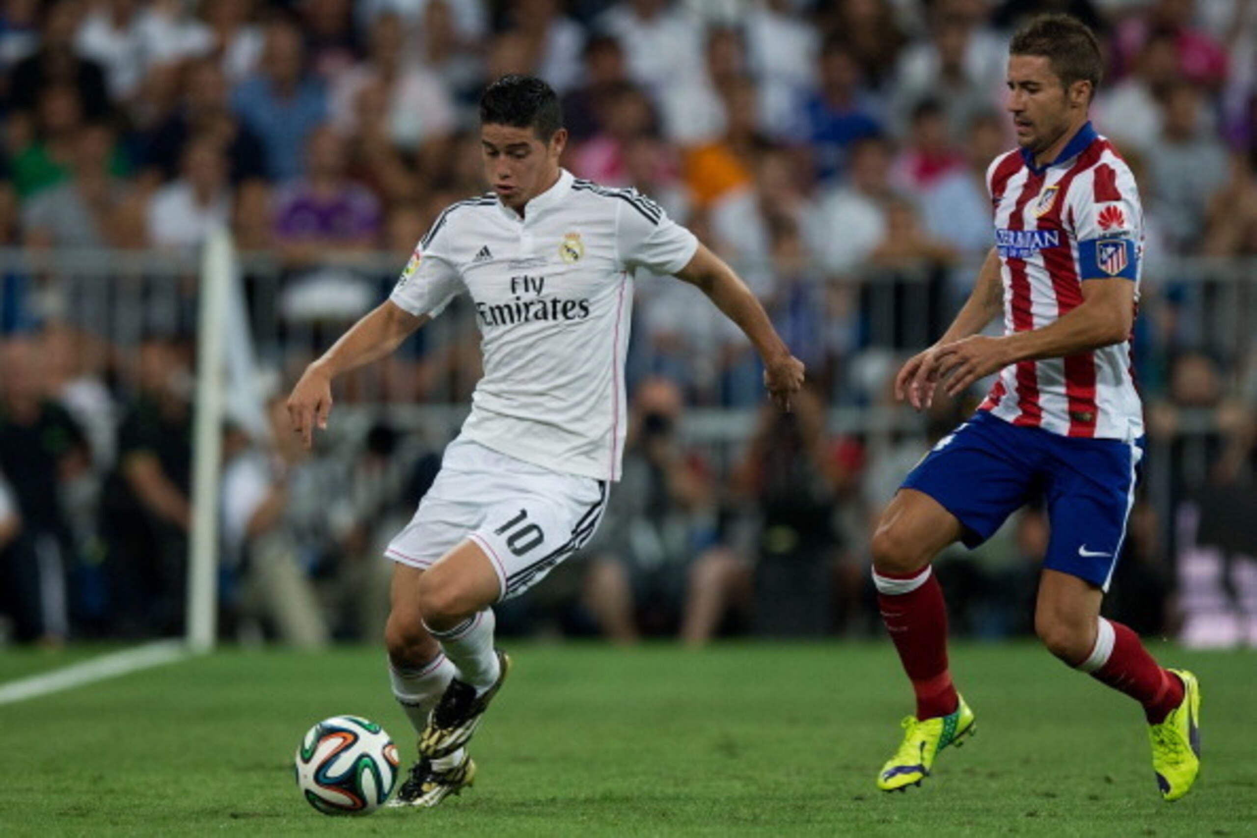 MADRID, SPAIN - AUGUST 19: James Rodriguez (L) of Real Madrid CF competes for the ball with Gabi Fernandez (R) of Atletico de Madrid during the Supercopa first leg match between Real Madrid and Club Atletico de Madrid at Estadio Santiago Bernabeu on Augus MADRID, SPAIN - AUGUST 19: James Rodriguez (L) of Real Madrid CF competes for the ball with Gabi Fernandez (R) of Atletico de Madrid during the Supercopa first leg match between Real Madrid and Club Atletico de Madrid at Estadio Santiago Bernabeu on Augus