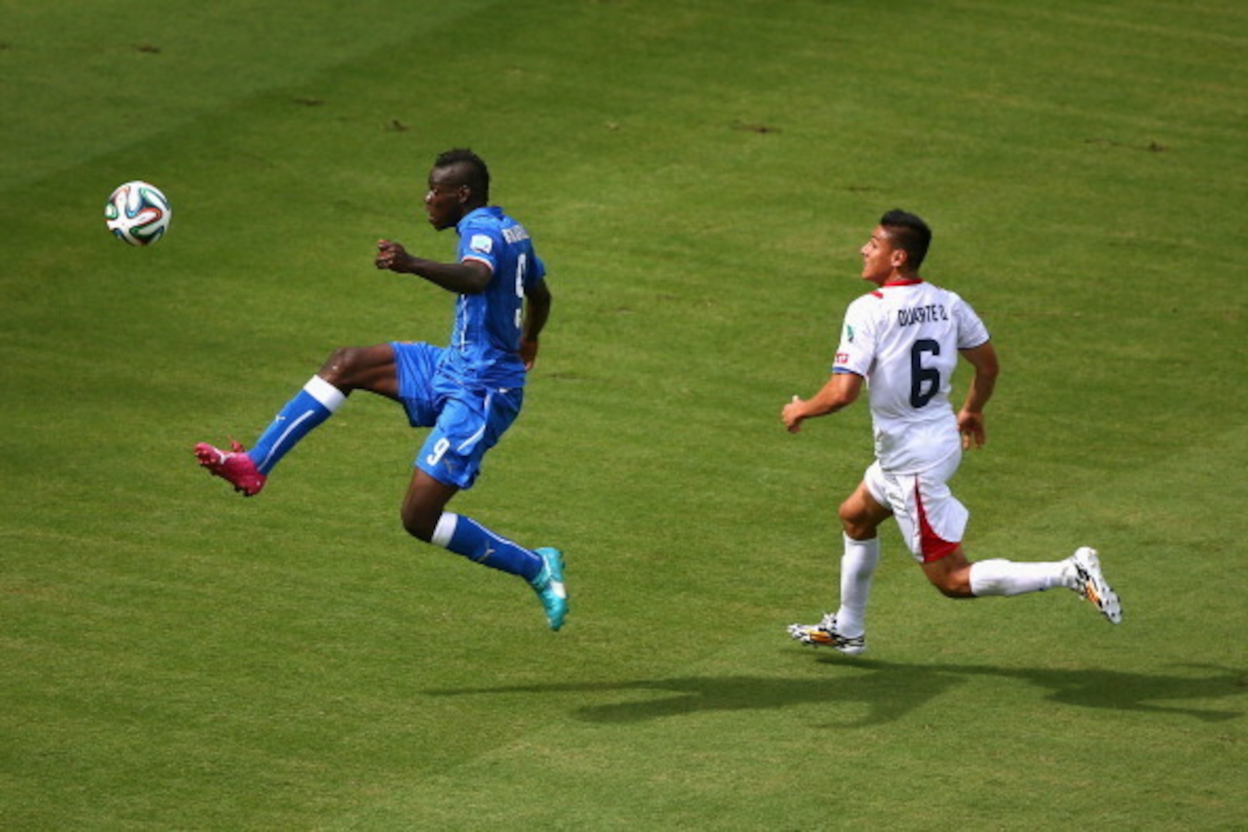 RECIFE, BRAZIL - JUNE 20:  Mario Balotelli of Italy shoots wide against Oscar Duarte of Costa Rica during the 2014 FIFA World Cup Brazil Group D match between Italy and Costa Rica at Arena Pernambuco on June 20, 2014 in Recife, Brazil.  (Photo by Michael 