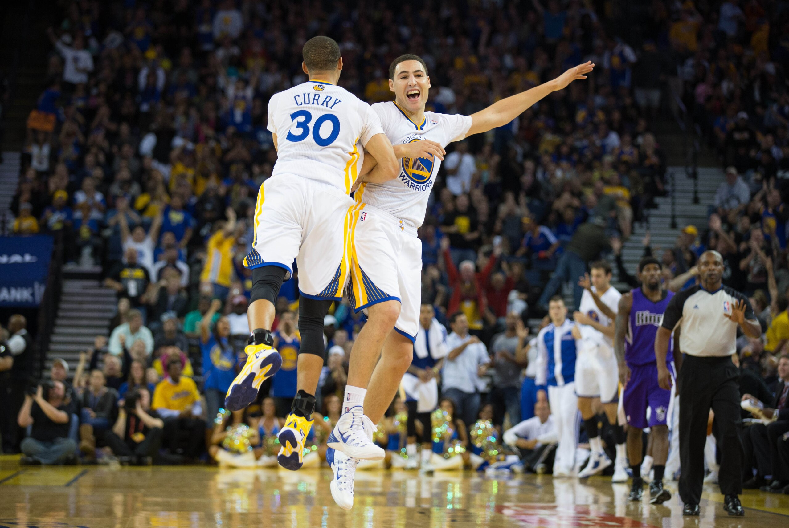 Nov 2, 2013; Oakland, CA, USA; Golden State Warriors shooting guard Klay Thompson (11) celebrates with point guard Stephen Curry (30) after scoring a three point basket against the Sacramento Kings during the second quarter at Oracle Arena. Mandatory Cred