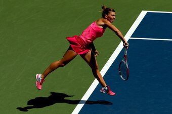 NEW YORK, NY - AUGUST 25:  Simona Halep of Romania serves to Danielle Rose Collins of the United States during their women's singles first round match on Day One of the 2014 US Open at the USTA Billie Jean King National Tennis Center on August 25, 2014  i