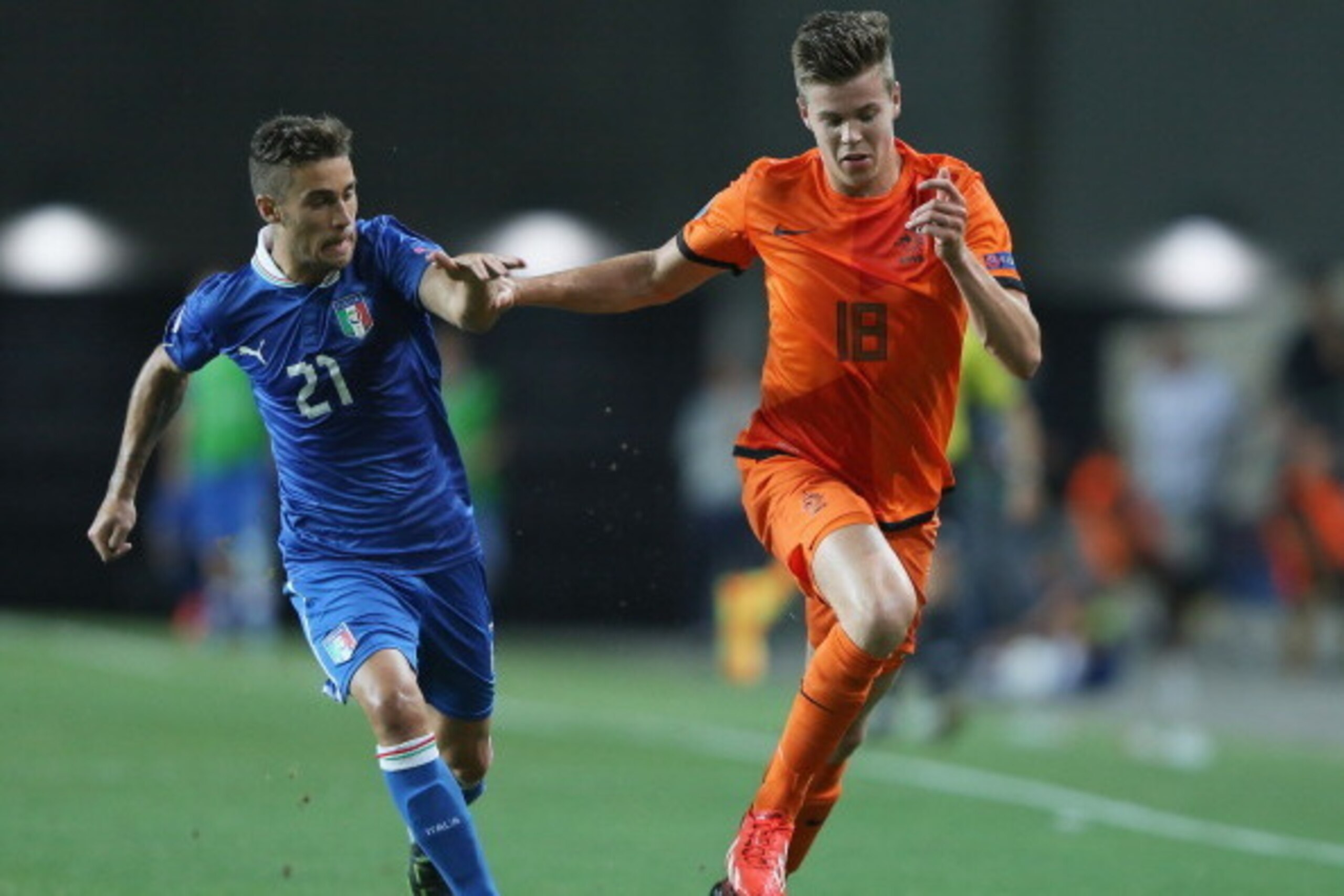 PETAH TIQWA, ISRAEL - JUNE 15:  Fausto Rossi of Italy tries to tackle Marco Van Ginkel of the Netherlands during the UEFA European U21 Championships semi- final match between Italy and the Netherlands at Ha Moshava Stadium on June 15, 2013 in Petah Tiqwa,
