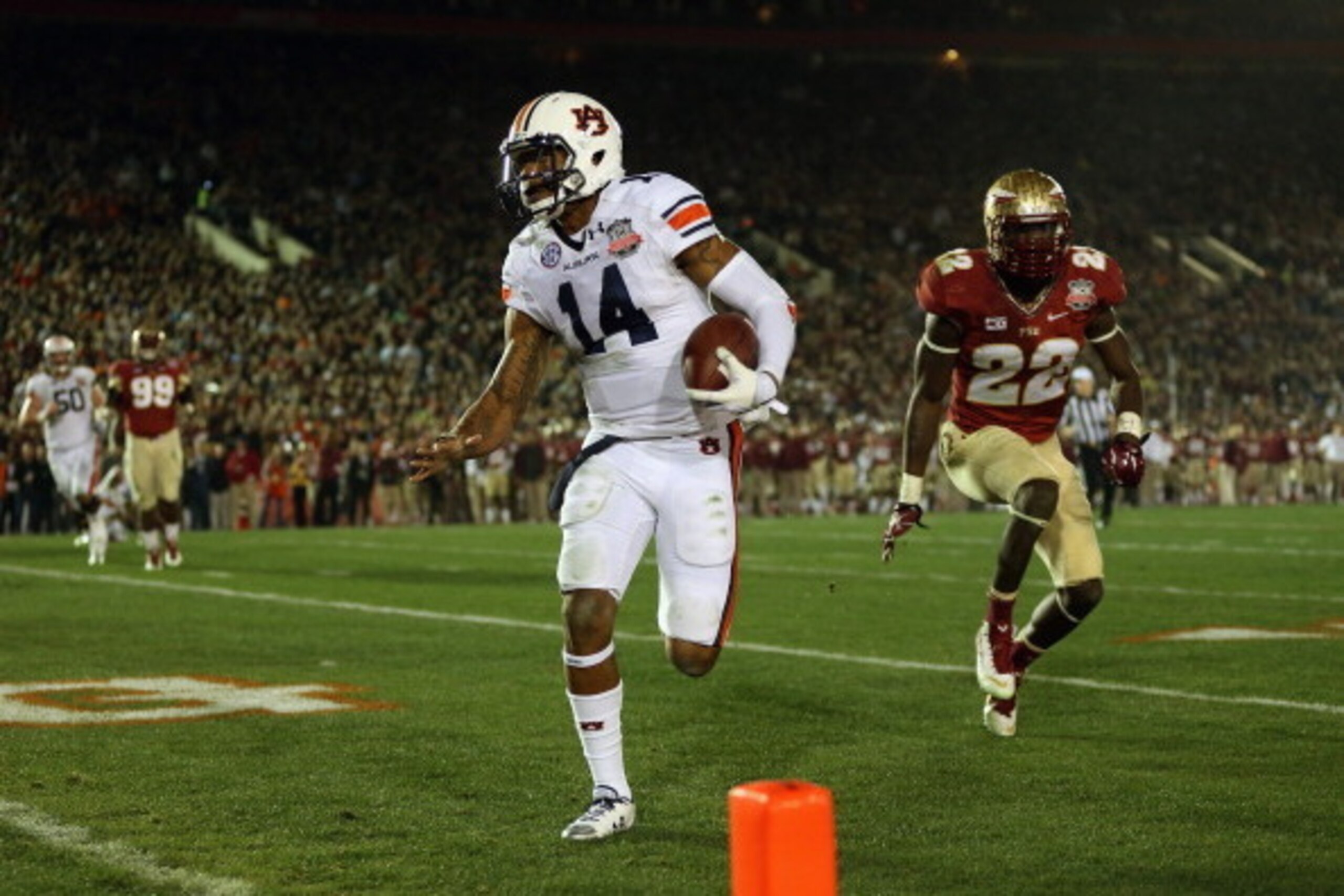 PASADENA, CA - JANUARY 06:  Quarterback Nick Marshall #14 of the Auburn Tigers runs for a four-yard touchdown in the 2014 Vizio BCS National Championship Game against the Florida State Seminoles at the Rose Bowl on January 6, 2014 in Pasadena, California.