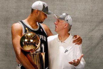 CLEVELAND - JUNE 14:  (L-R) Tim Duncan #21 and head Gregg Popovich of the San Antonio Spurs pose for a photo with the Larry O'Brien Championship trophy after they won the 2007 NBA Championship with their 83-82 win against the Cleveland Cavaliers in Game F