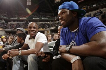 INDIANAPOLIS, IN - FEBRUARY 4:  Boxer Floyd Mayweather Jr. (L) and musician Curtis '50 Cent' Jackson (R) talk during the game between the Orlando Magic and Indiana Pacers on February 4, 2012 at Bankers Life Fieldhouse in Indianapolis, Indiana.  NOTE TO US