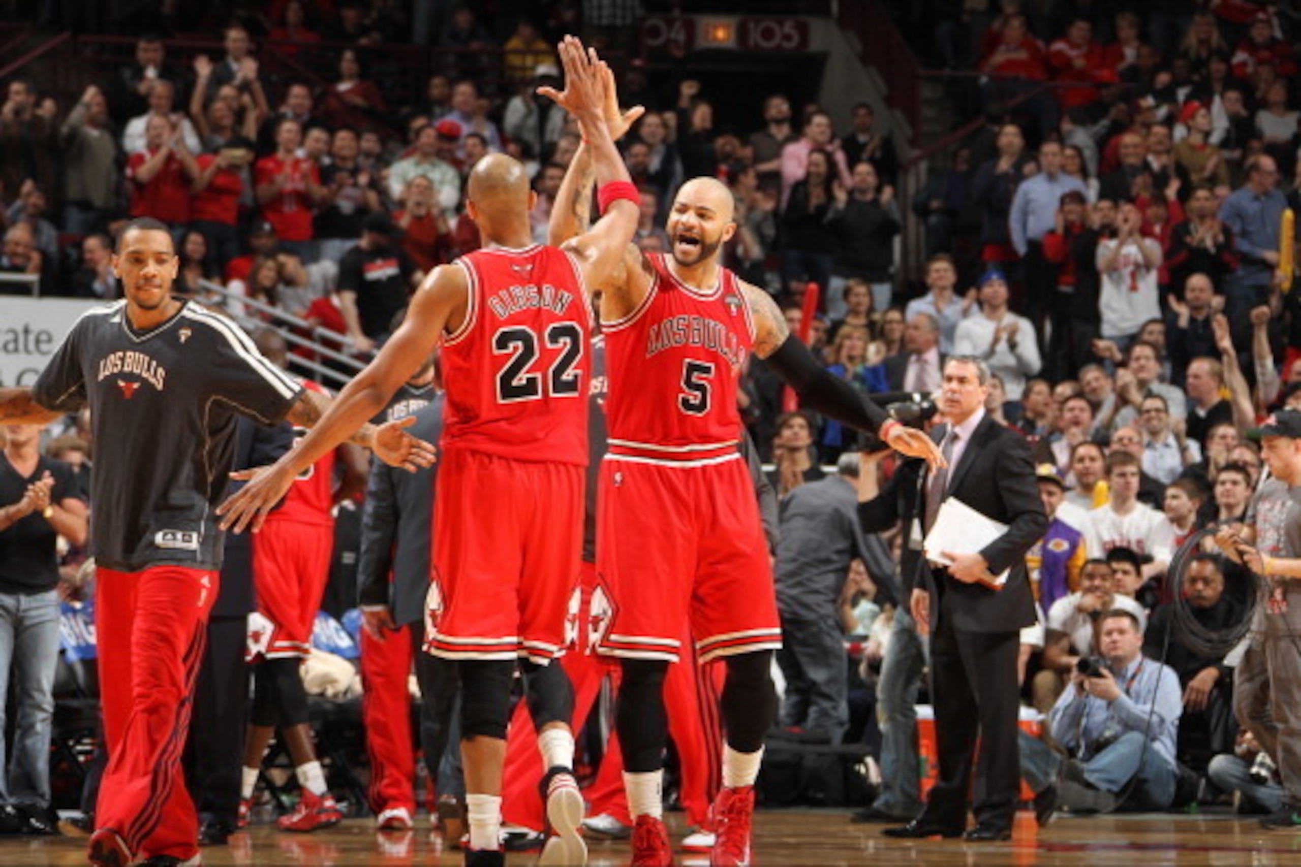 CHICAGO, IL - MARCH 27: Carlos Boozer #5 celebrates with Taj Gibson #22 and Daequan Cook #14 of the Chicago Bulls during the game against the Miami Heat on March 27, 2013 at the United Center in Chicago, Illinois. NOTE TO USER: User expressly acknowledges