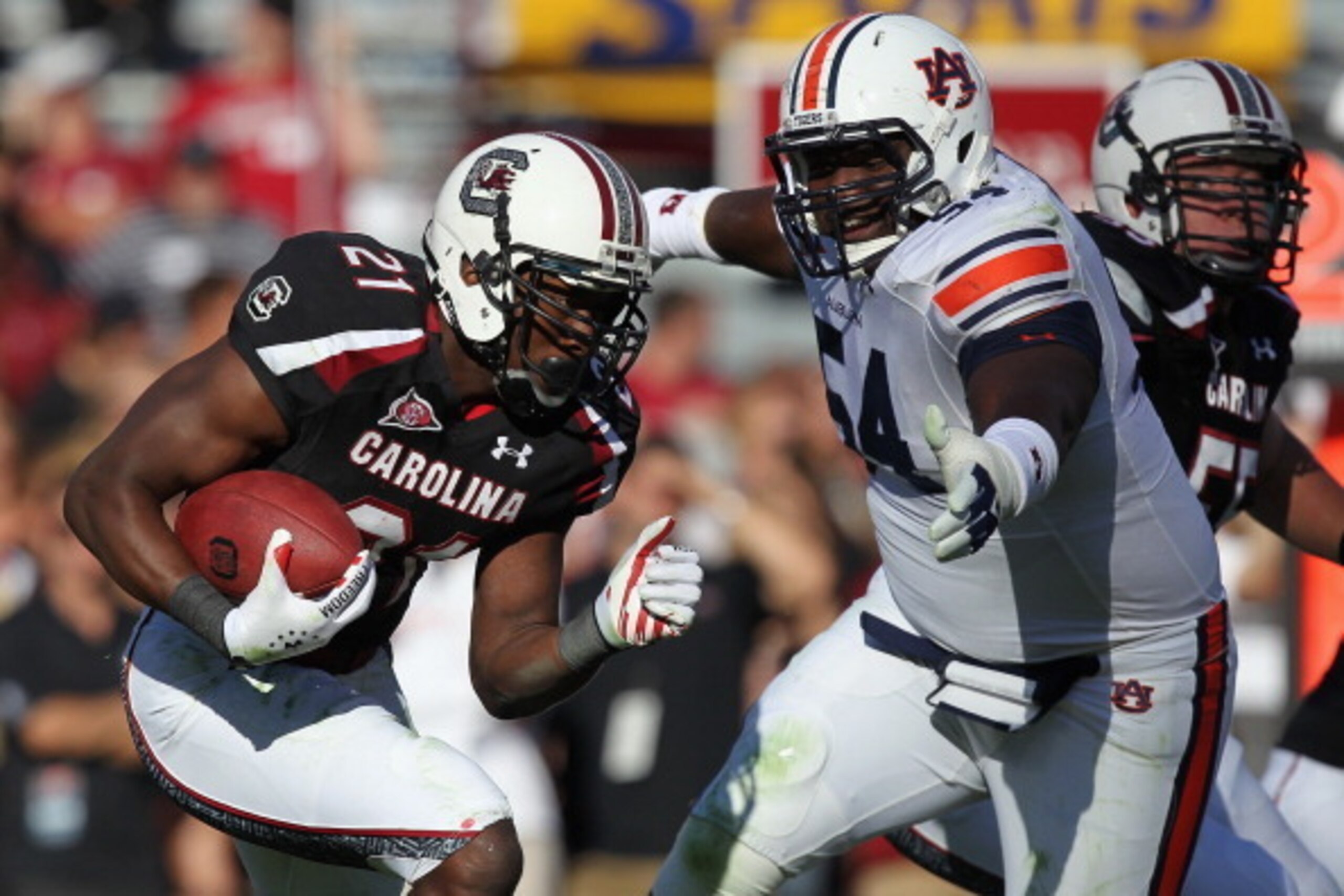 COLUMBIA, SC - OCTOBER 01:  Marcus Lattimore #21 of the South Carolina Gamecocks runs with the ball against Jeffrey Whitaker #54 of the Auburn Tigers during their game at Williams-Brice Stadium on October 1, 2011 in Columbia, South Carolina.  (Photo by St