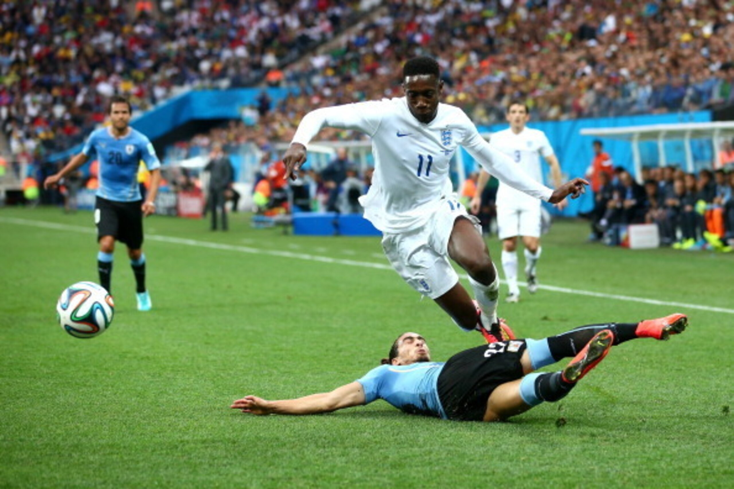 SAO PAULO, BRAZIL - JUNE 19:  Martin Caceres of Uruguay tackles Danny Welbeck during the 2014 FIFA World Cup Brazil Group D match between Uruguay and England at Arena de Sao Paulo on June 19, 2014 in Sao Paulo, Brazil.  (Photo by Julian Finney/Getty Image