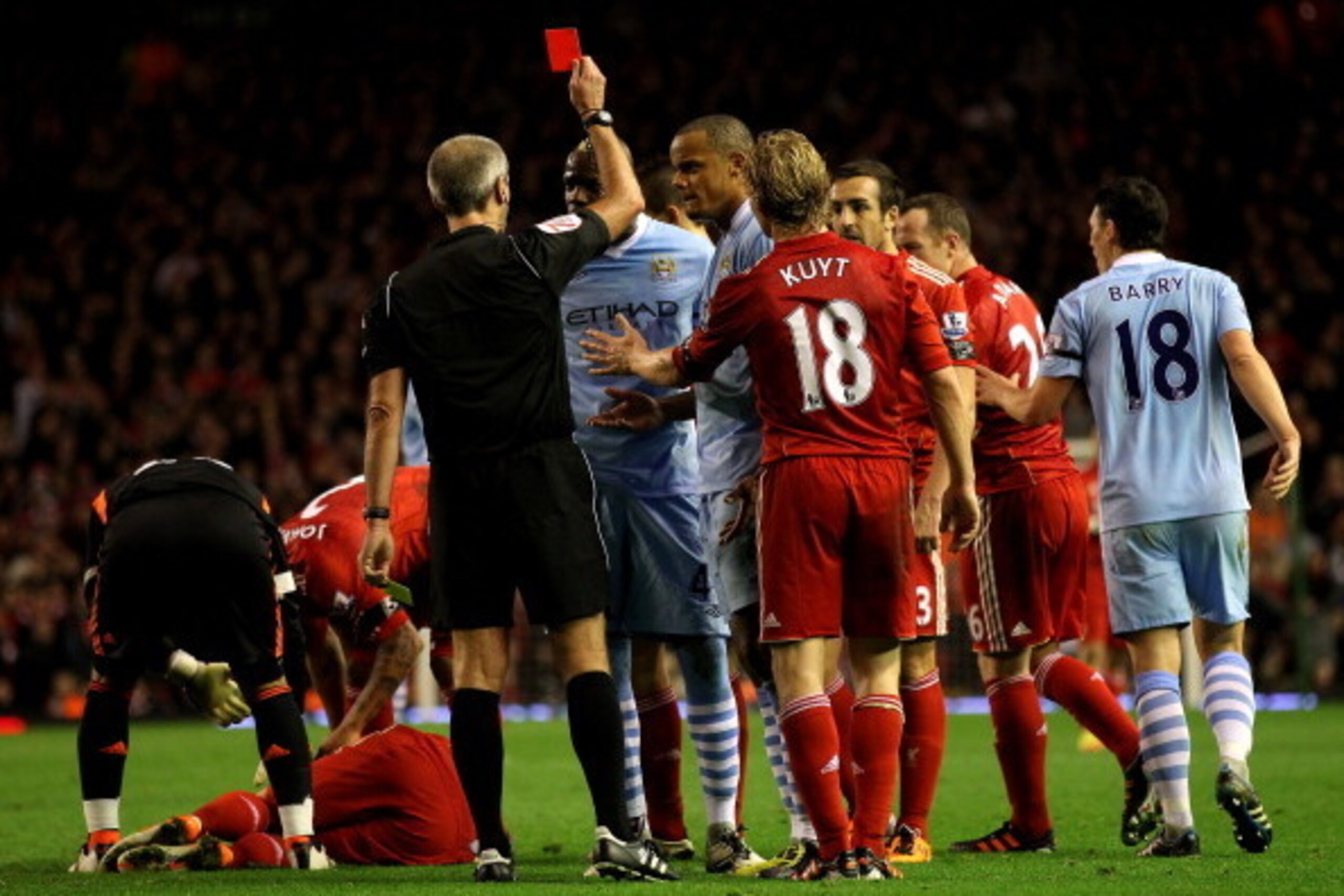 LIVERPOOL, ENGLAND - NOVEMBER 27:  Mario Balotelli of Manchester City is shown a red card by Referee Martin Atkinson during the Barclays Premier League match between Liverpool and Manchester City at Anfield on November 27, 2011 in Liverpool, England.  (Ph