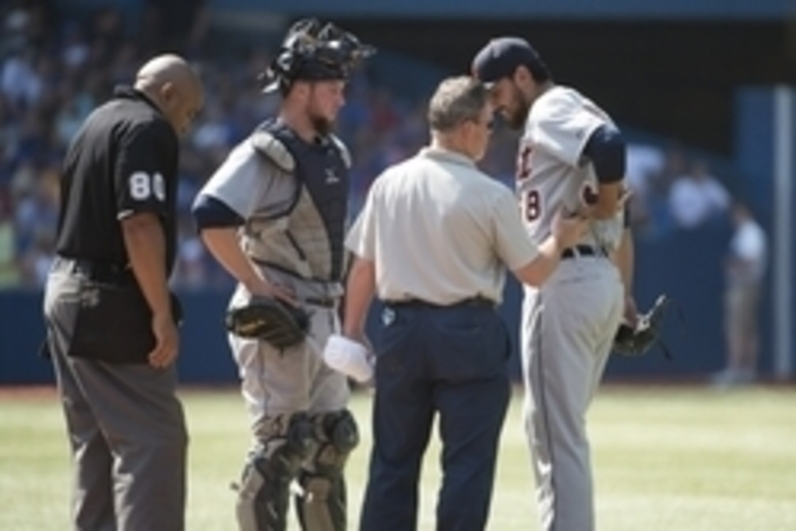 Aug 9, 2014; Toronto, Ontario, CAN; Detroit Tigers relief pitcher Joakim Soria (38) is looked at by the trainer during the tenth inning in a game against the Toronto Blue Jays at Rogers Centre. The Toronto Blue Jays won 3-2. Mandatory Credit: Nick Turchia