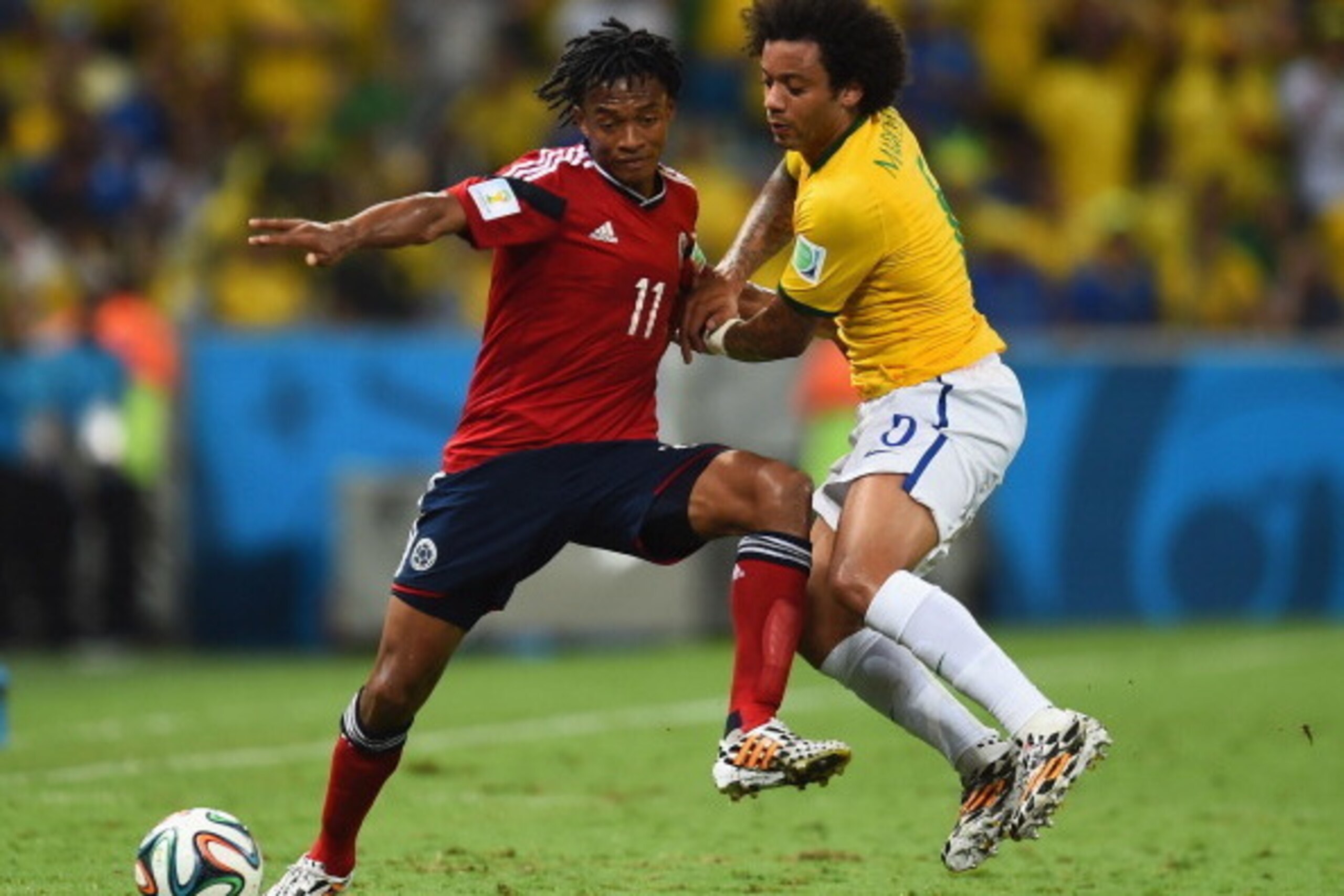 FORTALEZA, BRAZIL - JULY 04:  Marcelo of Brazil challenges Juan Guillermo Cuadrado of Colombia during the 2014 FIFA World Cup Brazil Quarter Final match between Brazil and Colombia at Castelao on July 4, 2014 in Fortaleza, Brazil.  (Photo by Jamie McDonal