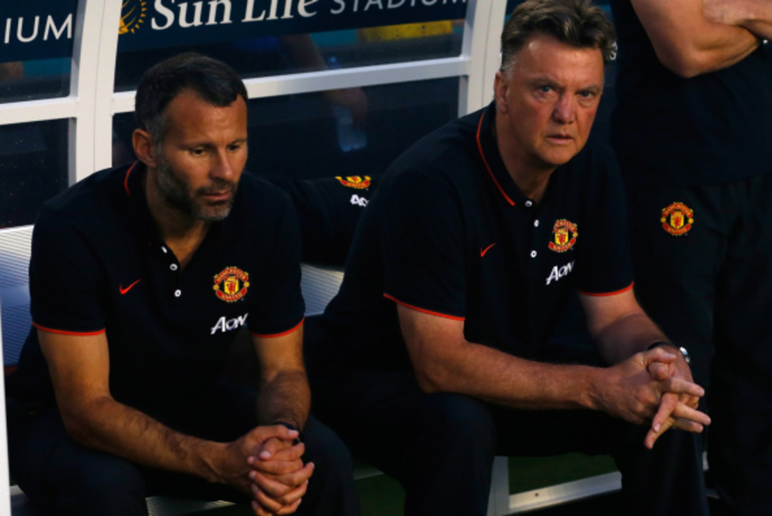 MIAMI GARDENS, FL - AUGUST 04: (L) Ryan Giggs and manager of Manchester United Louis Van Gaal sit on the bench prior to the game against Liverpool in the Guinness International Champions Cup 2014 Final at Sun Life Stadium on August 4, 2014 in Miami Garden
