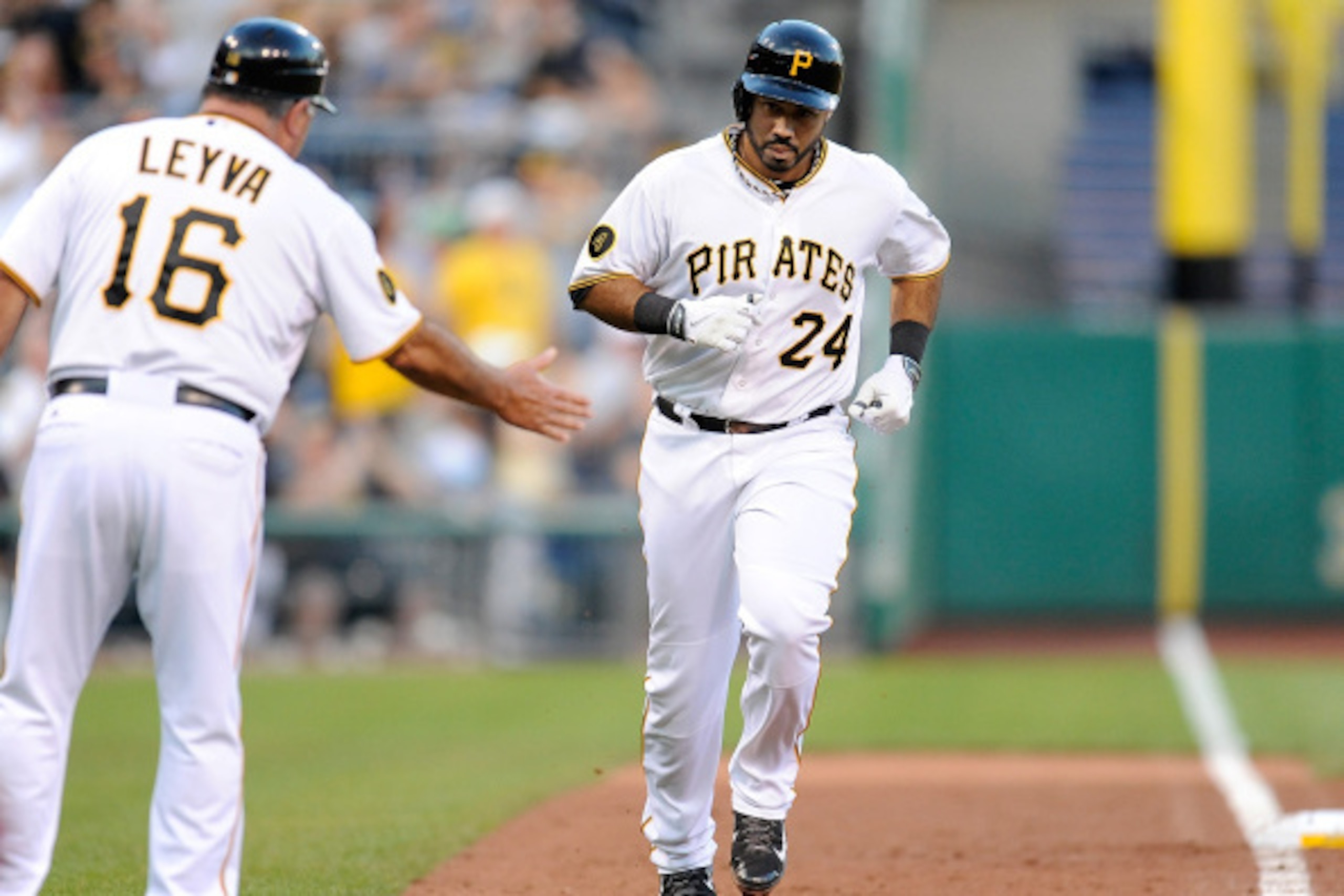 PITTSBURGH, PA - AUGUST 25:  Pedro Alvarez #24 of the Pittsburgh Pirates celebrates his solo home run with third base coach Nick Leyva during the second inning against the St. Louis Cardinals on August 25, 2014 at PNC Park in Pittsburgh, Pennsylvania.  (P