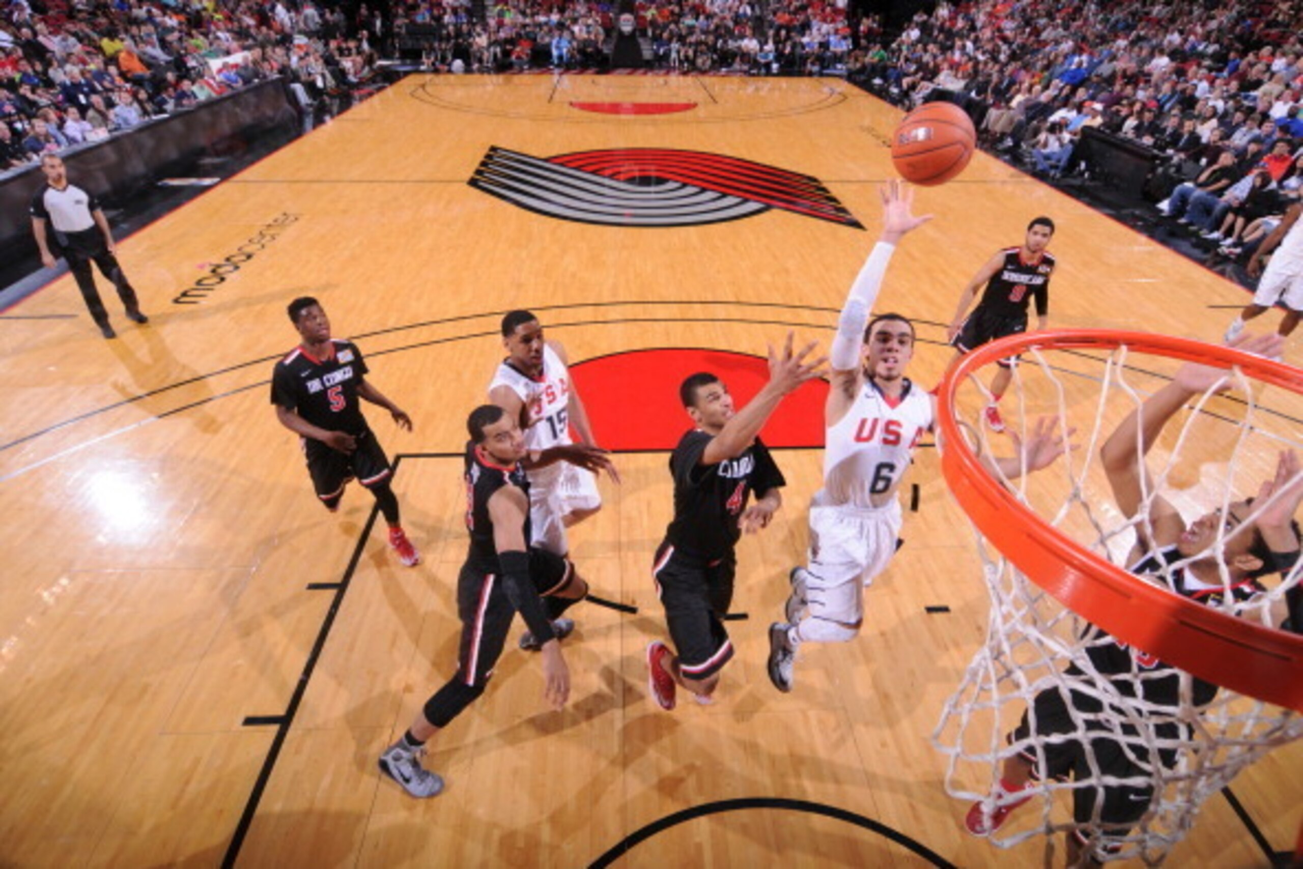 PORTLAND, OR - APRIL 12:  Tyus Jones #6 of Team USA drives to the basket against the World Team on April 12, 2014 at the Moda Center Arena in Portland, Oregon. NOTE TO USER: User expressly acknowledges and agrees that, by downloading and or using this pho