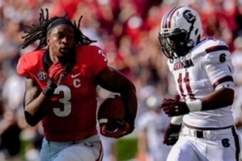 Sep 7, 2013; Athens, GA, USA; Georgia Bulldogs running back Todd Gurley (3) runs after losing his helmet past South Carolina Gamecocks linebacker T.J. Holloman (11)  during the second quarter at Sanford Stadium. Mandatory Credit: Dale Zanine-USA TODAY Spo