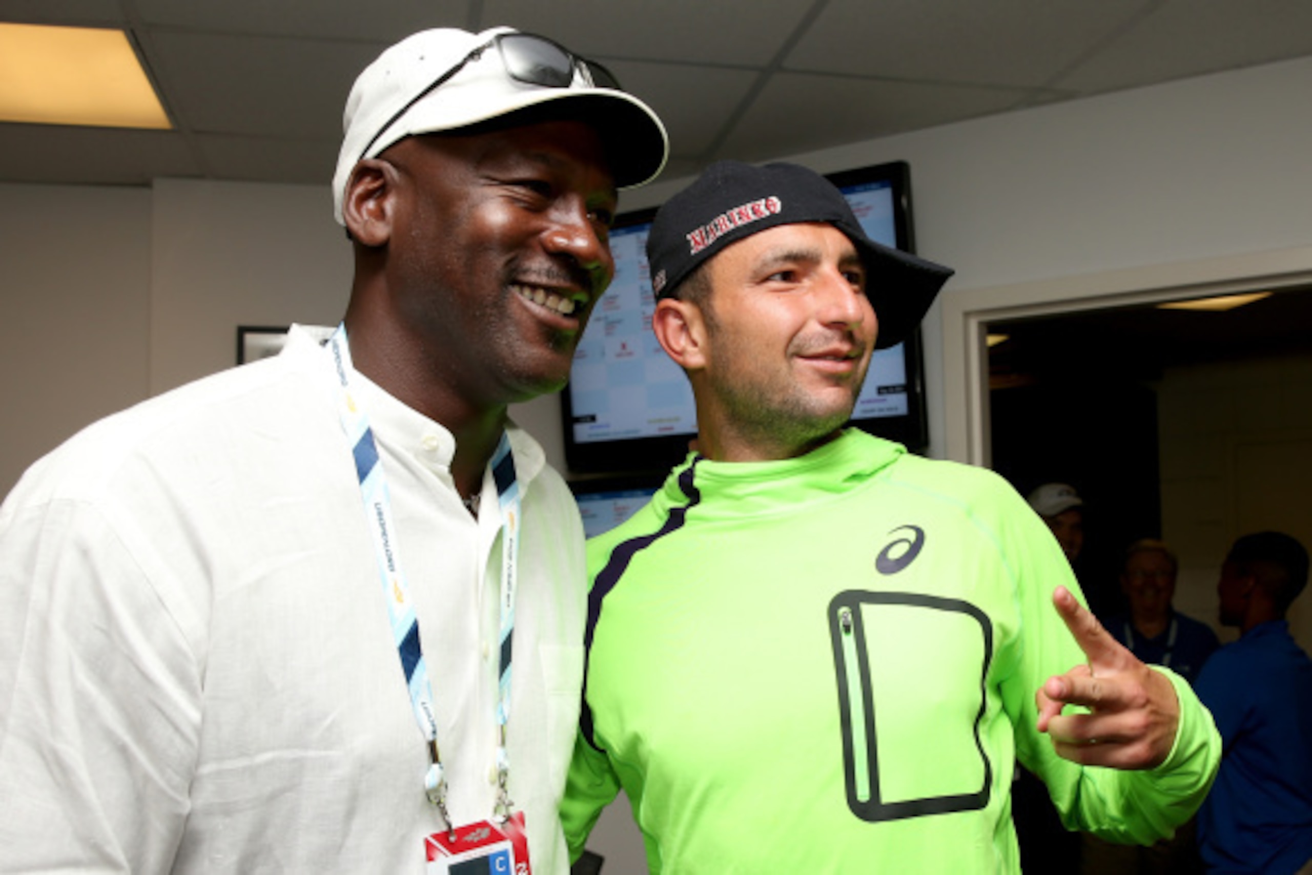 NEW YORK, NY - AUGUST 26:  Marinko Matosevic of Australia poses with basketball Hall of Famer Michael Jordan following his men's singles first round match against  Roger Federer of Switzerland on Day Two of the 2014 US Open at the USTA Billie Jean King Na