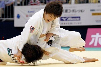FUKUOKA, JAPAN - MAY 13:  Nae Udaka (top) reacts after throwing Aiko Sato to win the Women's 57kg match during day two of the All Japan Judo Weight Class Championships 2012 at Fukuoka Kokusai Center on May 13, 2012 in Fukuoka, Japan.  (Photo by Kiyoshi Ot