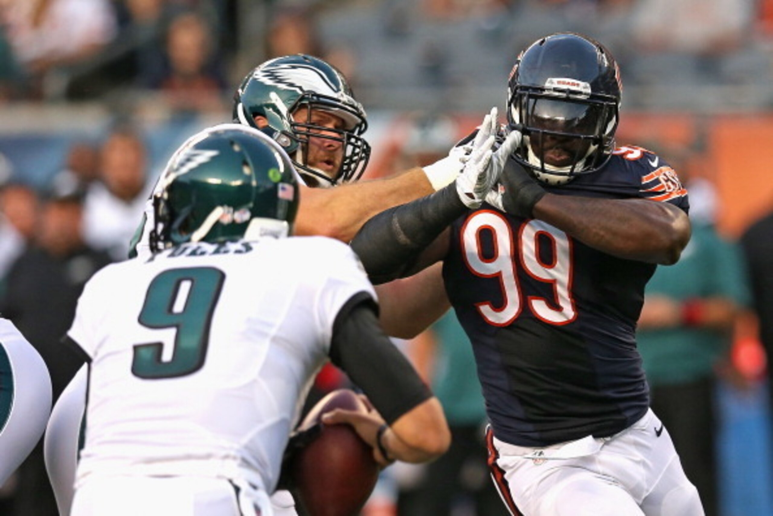 CHICAGO, IL - AUGUST 08:  Lamarr Houston #99 of the Chicago Bears rushes against Allen Barbre #76 of the Philadelphia Eagles during a preseason game at Soldier Field on August 8, 2014 in Chicago, Illinois.  (Photo by Jonathan Daniel/Getty Images)