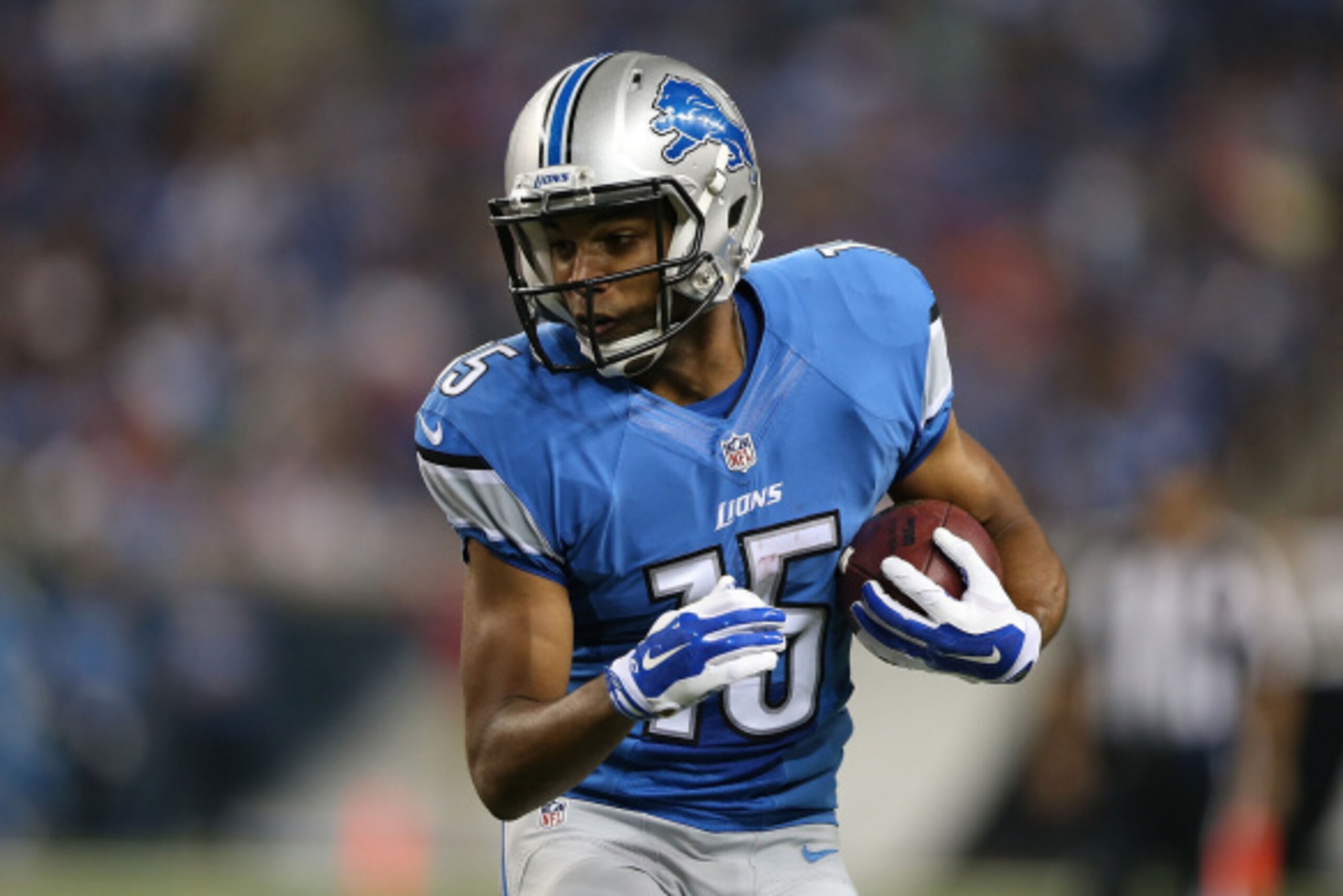 DETROIT, MI - AUGUST 22:  Golden Tate #15 of the Detroit Lions runs for a short gain during the first half of the preseason game against the Jacksonville Jaguars at Ford Field on August 22, 2014 in Detroit, Michigan. The Lions defeated the Jaguars 13-12. 