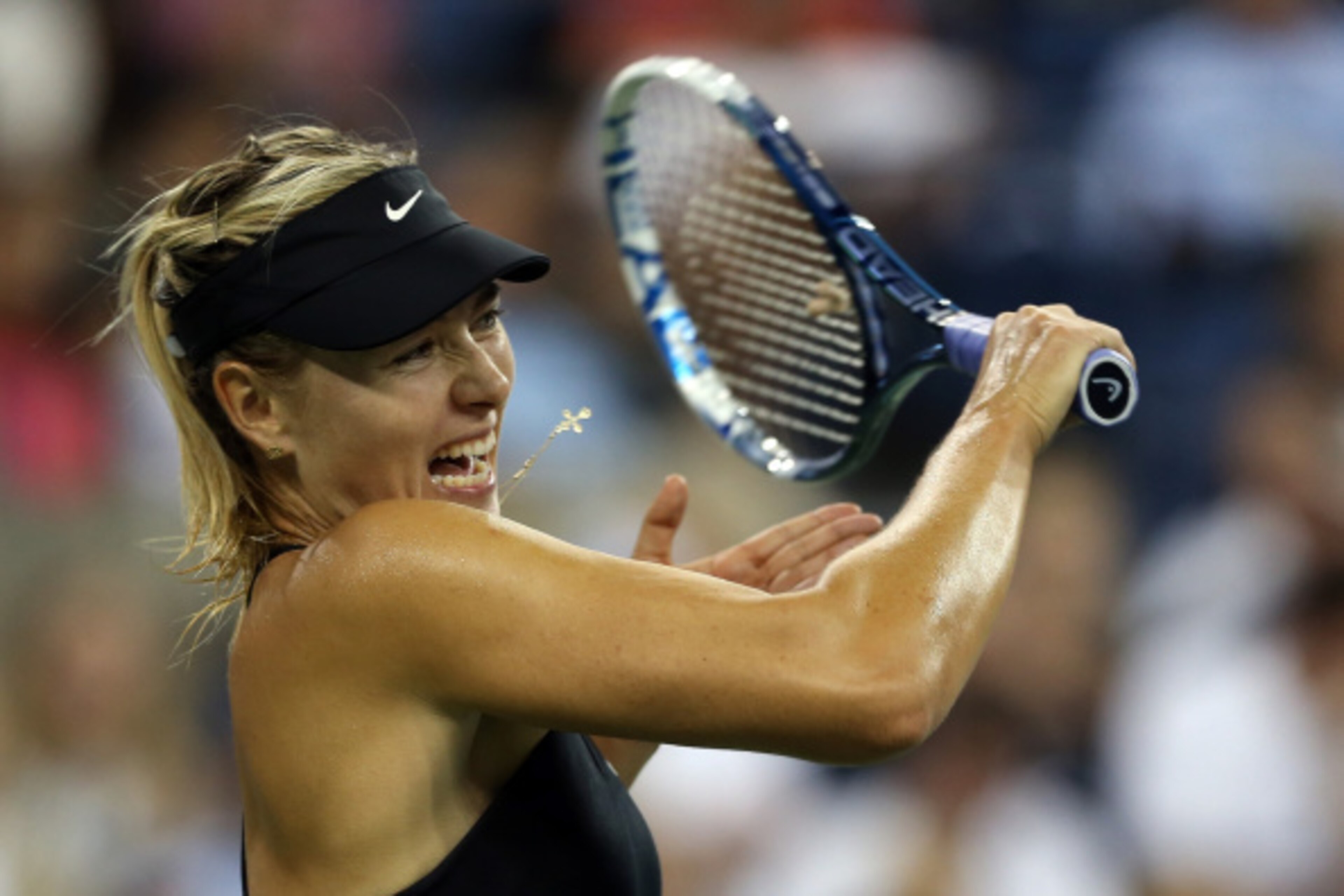 NEW YORK, NY - AUGUST 25: Maria Sharapova of Russia returns a shot against Maria Kirilenko of Russia during her women's singles first round match on Day One of the 2014 US Open at the USTA Billie Jean King National Tennis Center on August 25, 2014 in th NEW YORK, NY - AUGUST 25: Maria Sharapova of Russia returns a shot against Maria Kirilenko of Russia during her women's singles first round match on Day One of the 2014 US Open at the USTA Billie Jean King National Tennis Center on August 25, 2014 in th