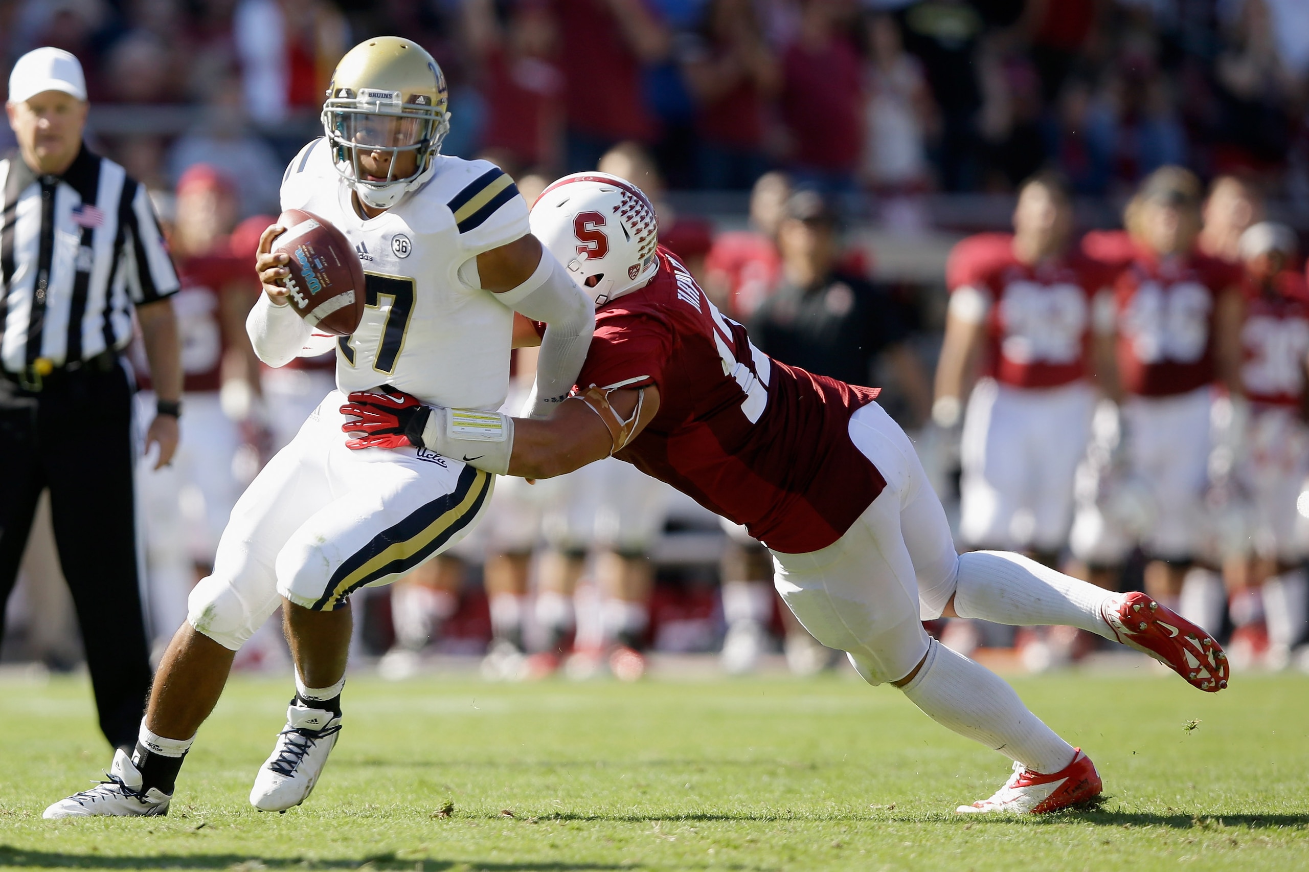 PALO ALTO, CA - OCTOBER 19:  Brett Hundley #17 of the UCLA Bruins is pressured by A.J. Tarpley #17 of the Stanford Cardinal at Stanford Stadium on October 19, 2013 in Palo Alto, California.  (Photo by Ezra Shaw/Getty Images)