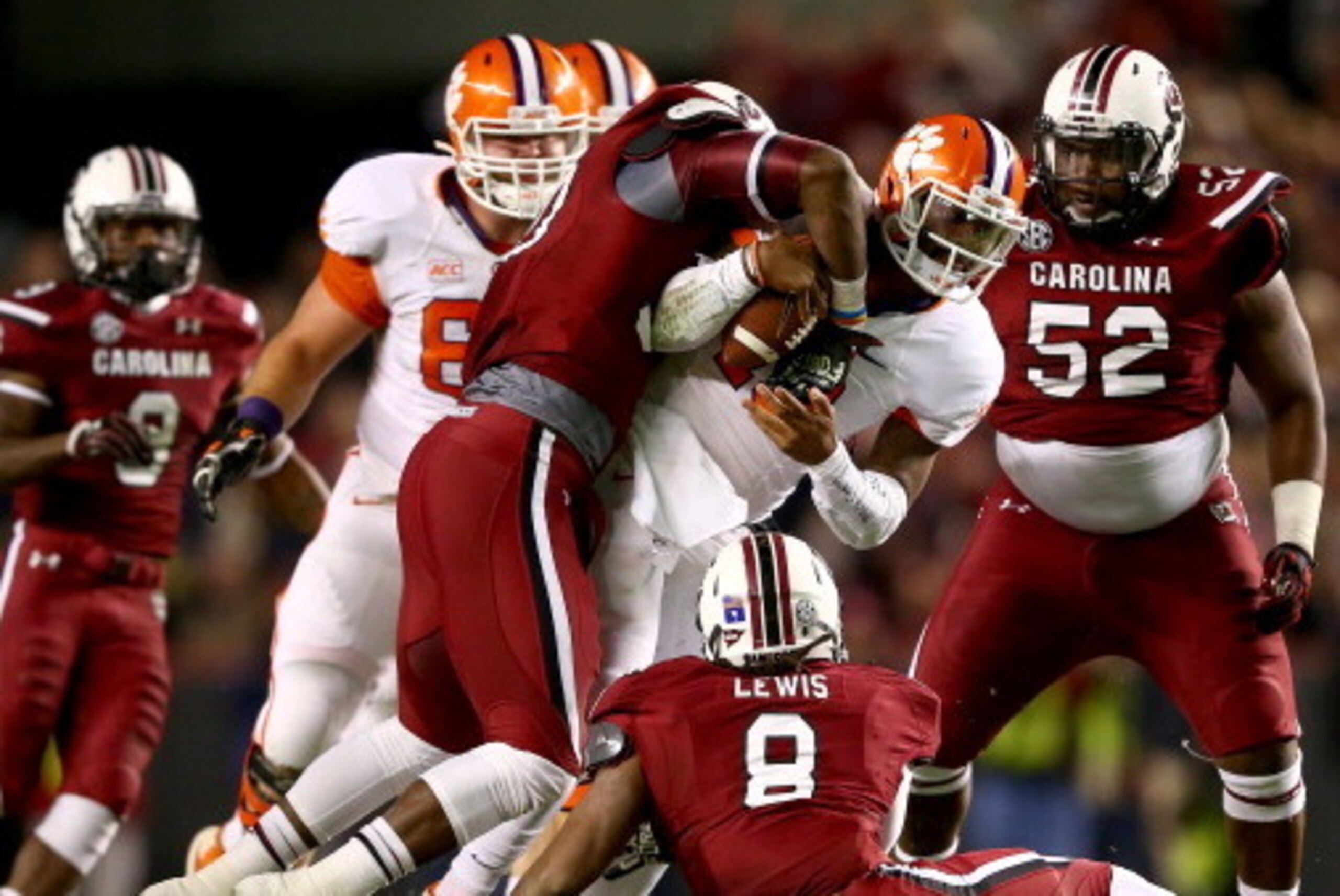 COLUMBIA, SC - NOVEMBER 30:  Chaz Sutton #90 of the South Carolina Gamecocks strips the ball from Tajh Boyd #10 of the Clemson Tigers during their game at Williams-Brice Stadium on November 30, 2013 in Columbia, South Carolina.  (Photo by Streeter Lecka/G