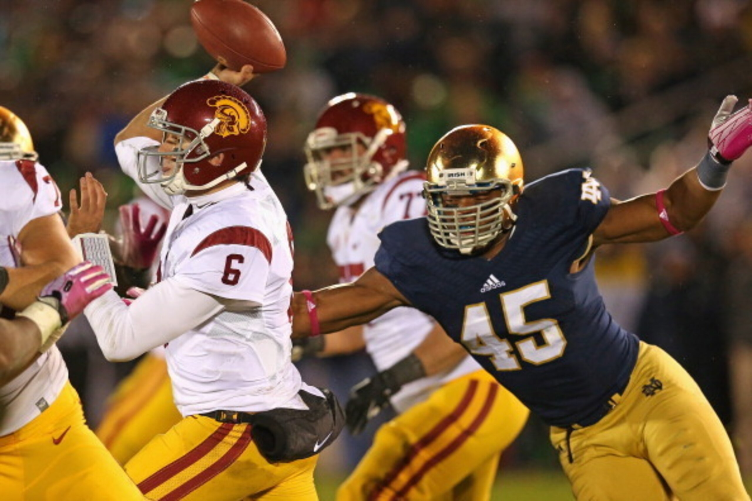 SOUTH BEND, IN - OCTOBER 19: Cody Kessler #6 of the University of Southern California Trojans passes as Romeo Okwara #45 of the Notre Dame Fighting Irish rushes at Notre Dame Stadium on October 19, 2013 in South Bend, Indiana. Notre Dame defeated USC 14-1 SOUTH BEND, IN - OCTOBER 19: Cody Kessler #6 of the University of Southern California Trojans passes as Romeo Okwara #45 of the Notre Dame Fighting Irish rushes at Notre Dame Stadium on October 19, 2013 in South Bend, Indiana. Notre Dame defeated USC 14-1