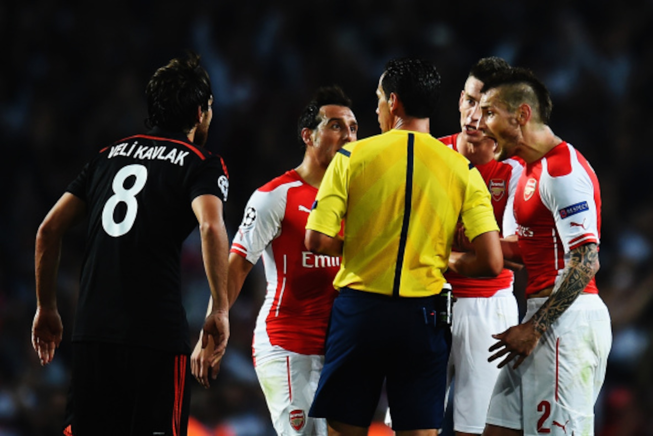 LONDON, ENGLAND - AUGUST 27:  Mathieu Debuchy (R) of Arsenal is sent off by match referee Pedro Proenca during the UEFA Champions League Qualifier 2nd leg match between Arsenal and Besiktas at the Emirates Stadium on August 27, 2014 in London, United King