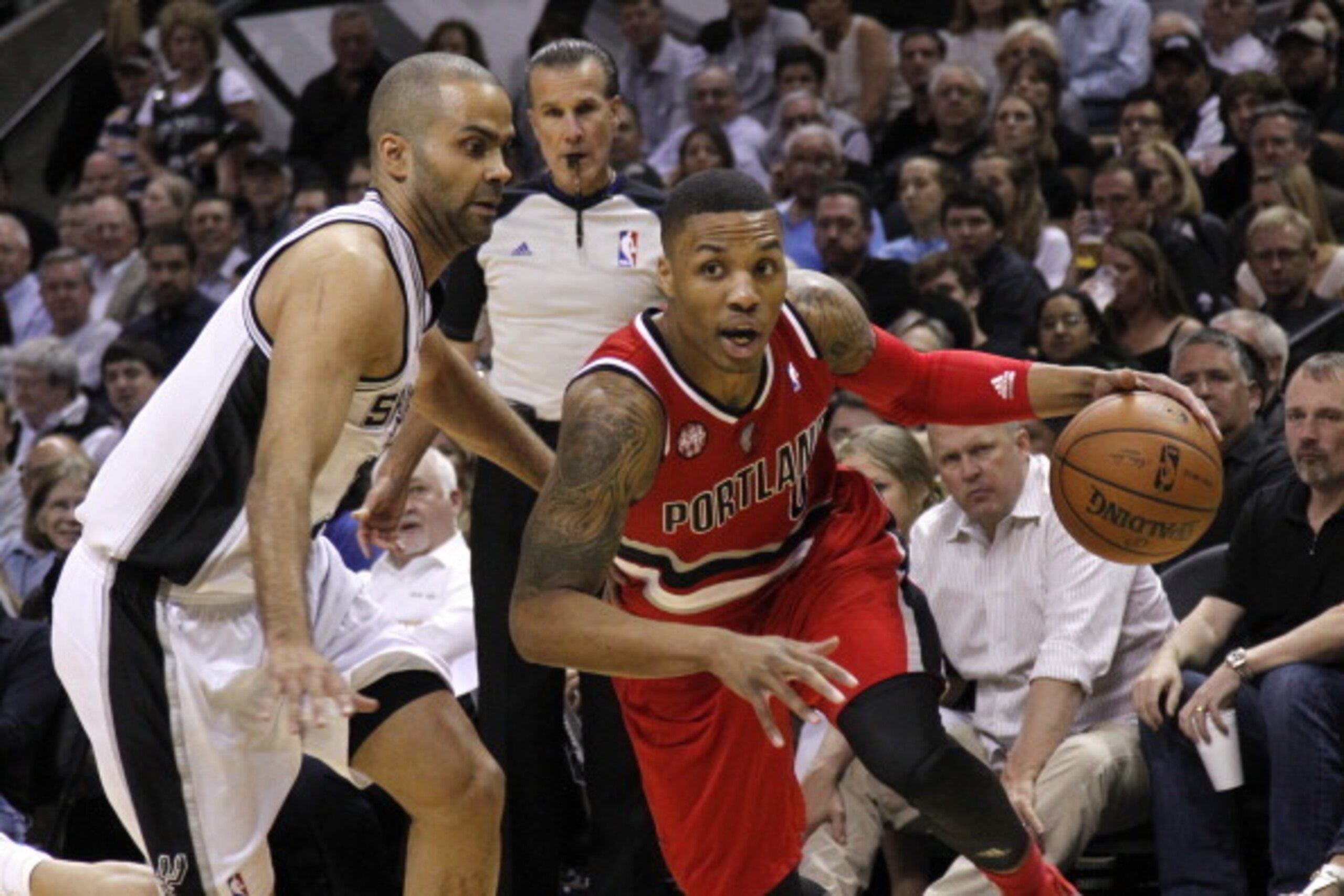 SAN ANTONIO, TX - MAY 14:  Damian Lillard #0 of the Portland Trail Blazers drives around Tony Parker #9 of the San Antonio Spurs in Game Five of the Western Conference Semifinals during the 2014 NBA Playoffs at the AT&T Center on May 14, 2014 in San Anton