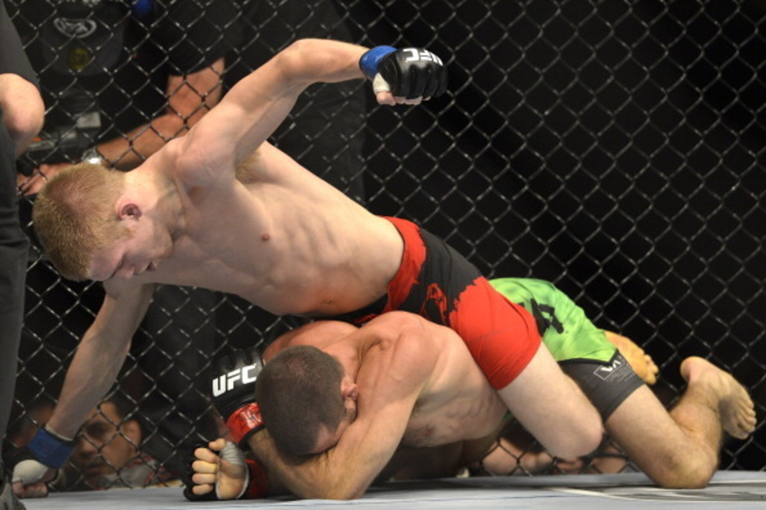 BRISBANE, AUSTRALIA - DECEMBER 07:  Justin Scoggins of the USA (top) punches Richie Vaculik of Australia in their flyweight fight during the UFC Fight Night event at the Brisbane Entertainment Centre on December 7, 2013 in Brisbane, Australia.  (Photo by