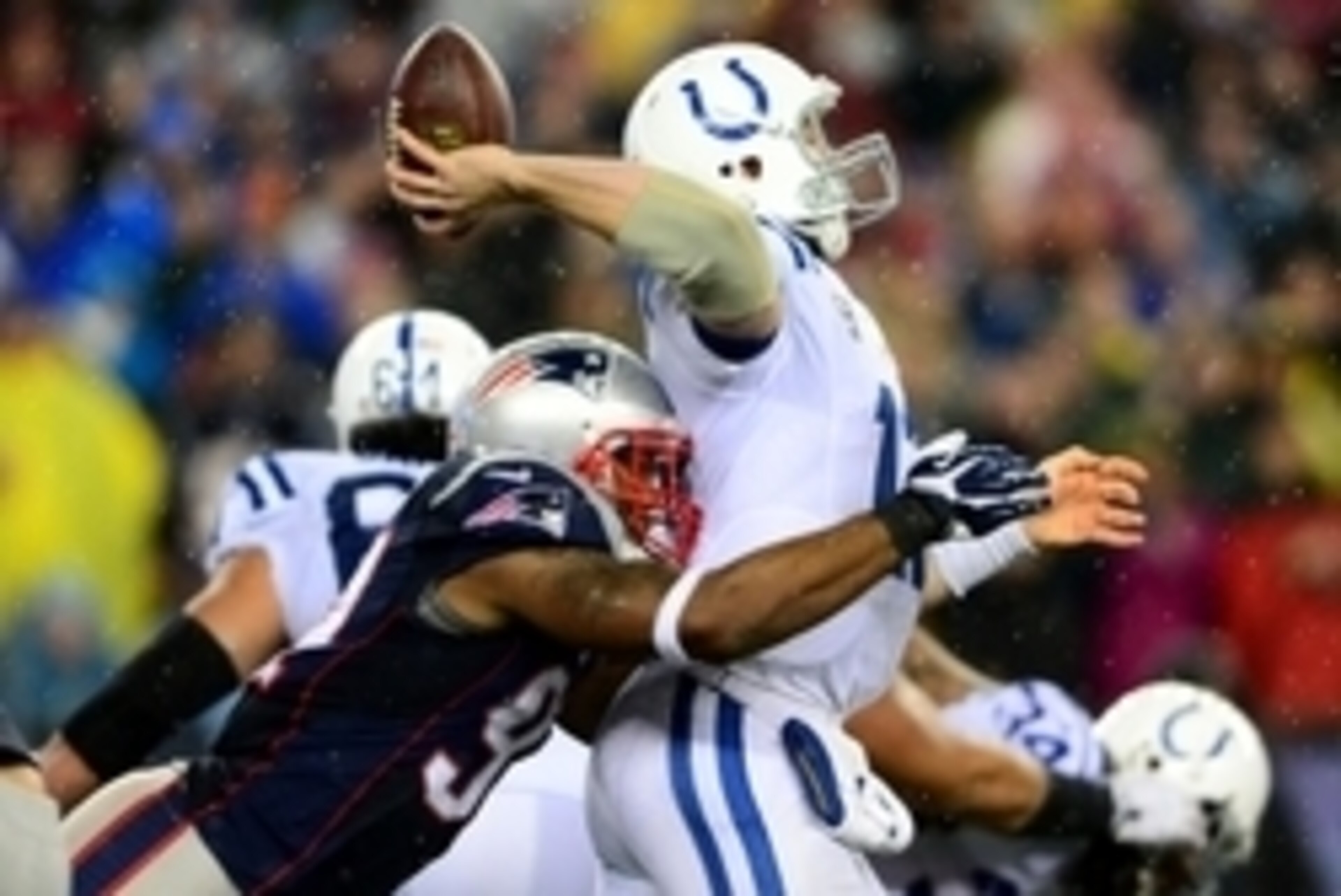 Jan 11, 2014; Foxborough, MA, USA; Indianapolis Colts quarterback Andrew Luck (12) throws a pass while being hit by New England Patriots outside linebacker Jamie Collins (91)  during the third quarter of the 2013 AFC divisional playoff football game at Gi