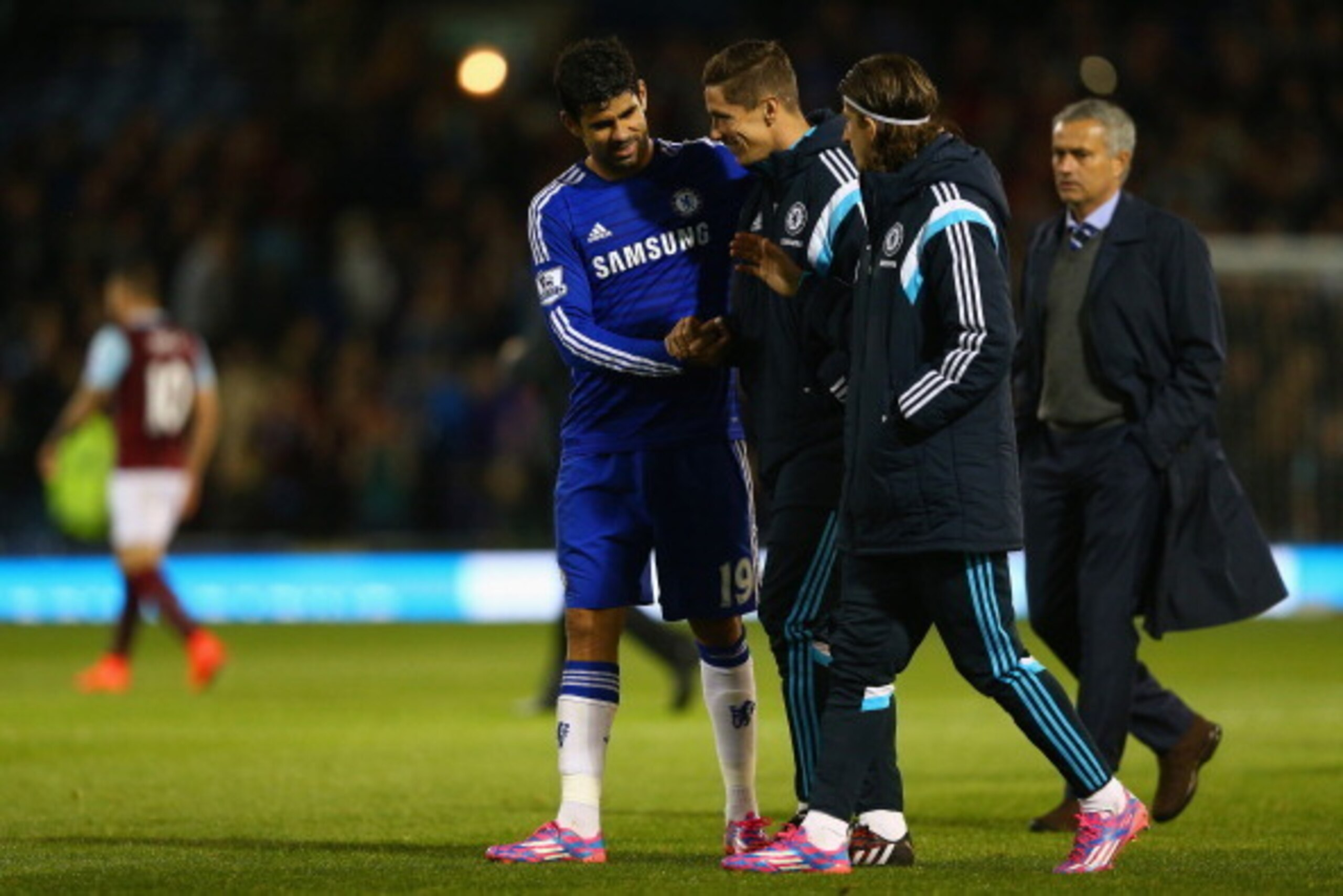 BURNLEY, ENGLAND - AUGUST 18: Diego Costa, Fernando Torres and Filipe Luis of Chelsea share a joke as Manager Jose Mourinho of Chelsea looks on after the Barclays Premier League match between Burnley and Chelsea at Turf Moor on August 18, 2014 in Burnley BURNLEY, ENGLAND - AUGUST 18: Diego Costa, Fernando Torres and Filipe Luis of Chelsea share a joke as Manager Jose Mourinho of Chelsea looks on after the Barclays Premier League match between Burnley and Chelsea at Turf Moor on August 18, 2014 in Burnley