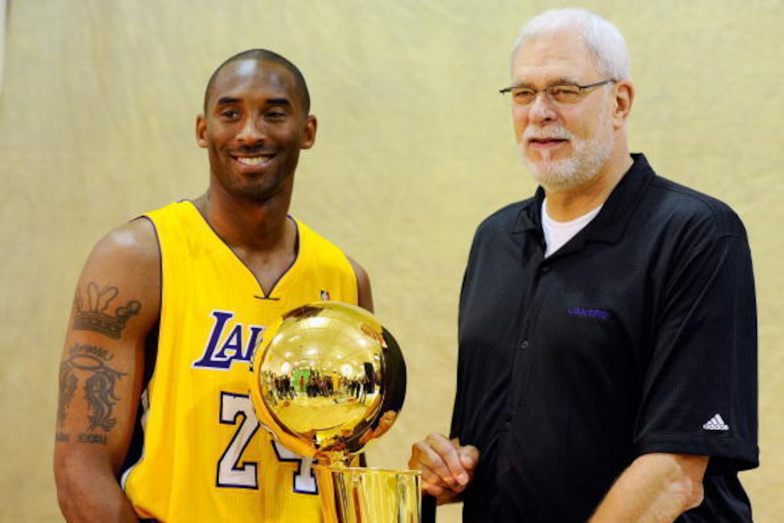 EL SEGUNDO, CA - SEPTEMBER 25:  Kobe Bryant #24 and head coach Phil Jackson of the Los Angeles Lakers pose with NBA Finals Larry O'Brien Championship Trophy during  Media Day at the Toyota Center on September 25, 2010 in El Segundo, California. NOTE TO US