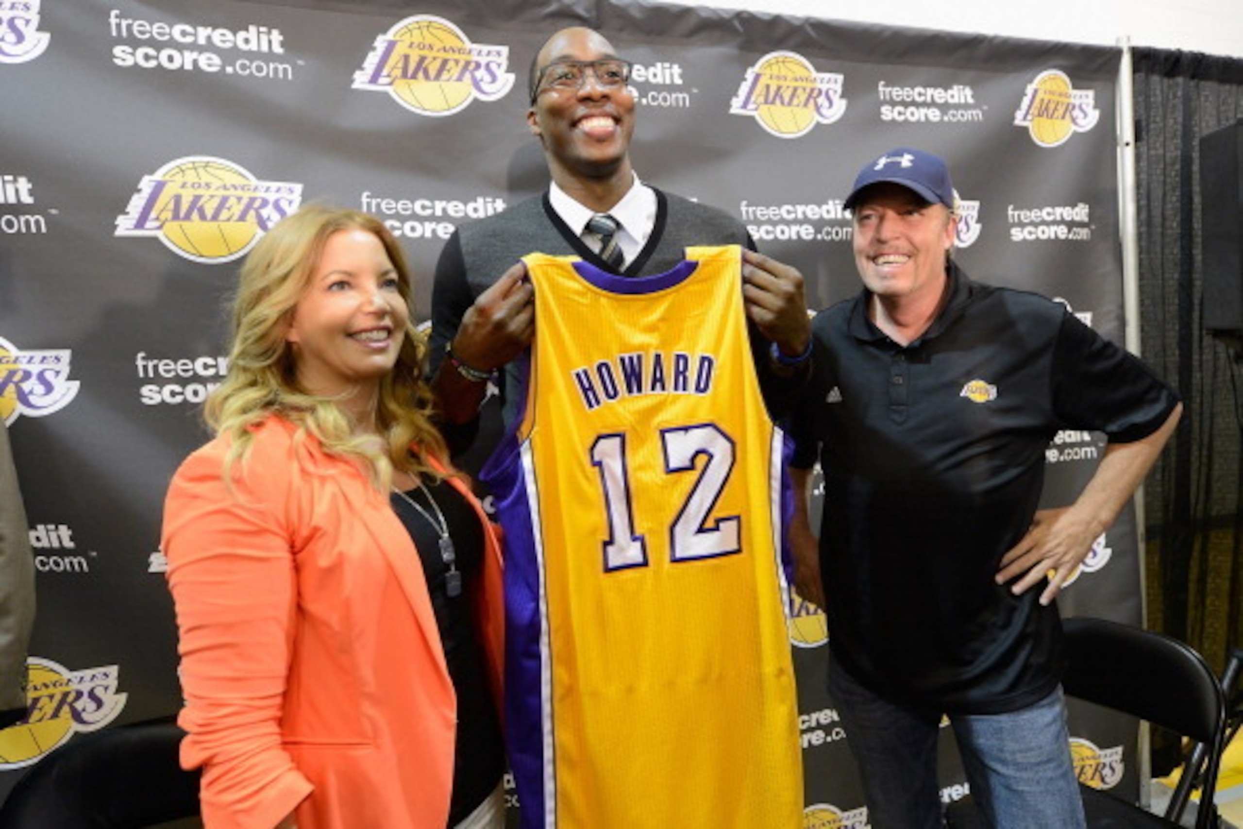 EL SEGUNDO, CA - AUGUST 10:  Jim Buss and his sister Jeanie Buss of the Los Angeles Lakers pose with  new member of the team Dwight Howard at the Toyota Sports Center on August 10, 2012 in El Segundo, California. The Lakers acquired Howard from Orlando Ma