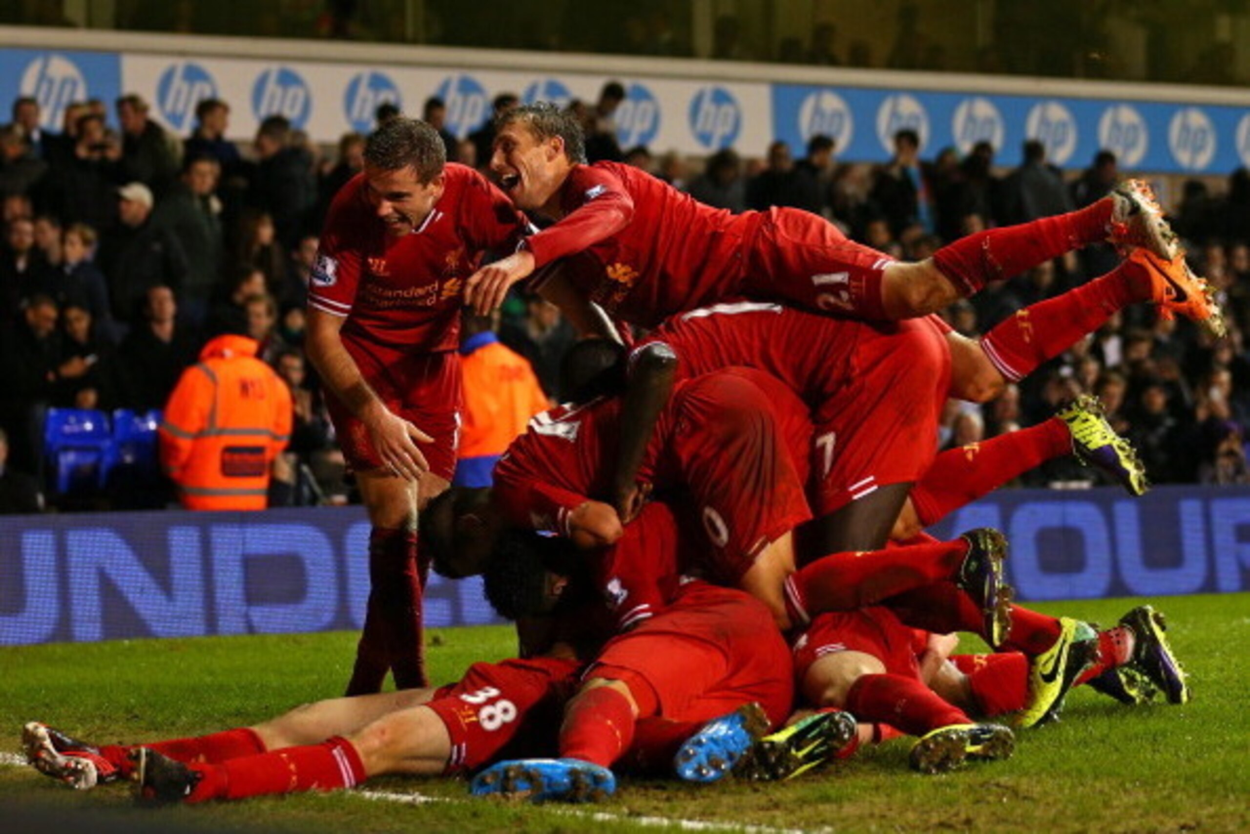 LONDON, ENGLAND - DECEMBER 15:  Jon Flanagan of Liverpool is mobbed by his team mates after scoring their third goal during the Barclays Premier League match between Tottenham Hotspur and Liverpool at White Hart Lane on December 15, 2013 in London, Englan
