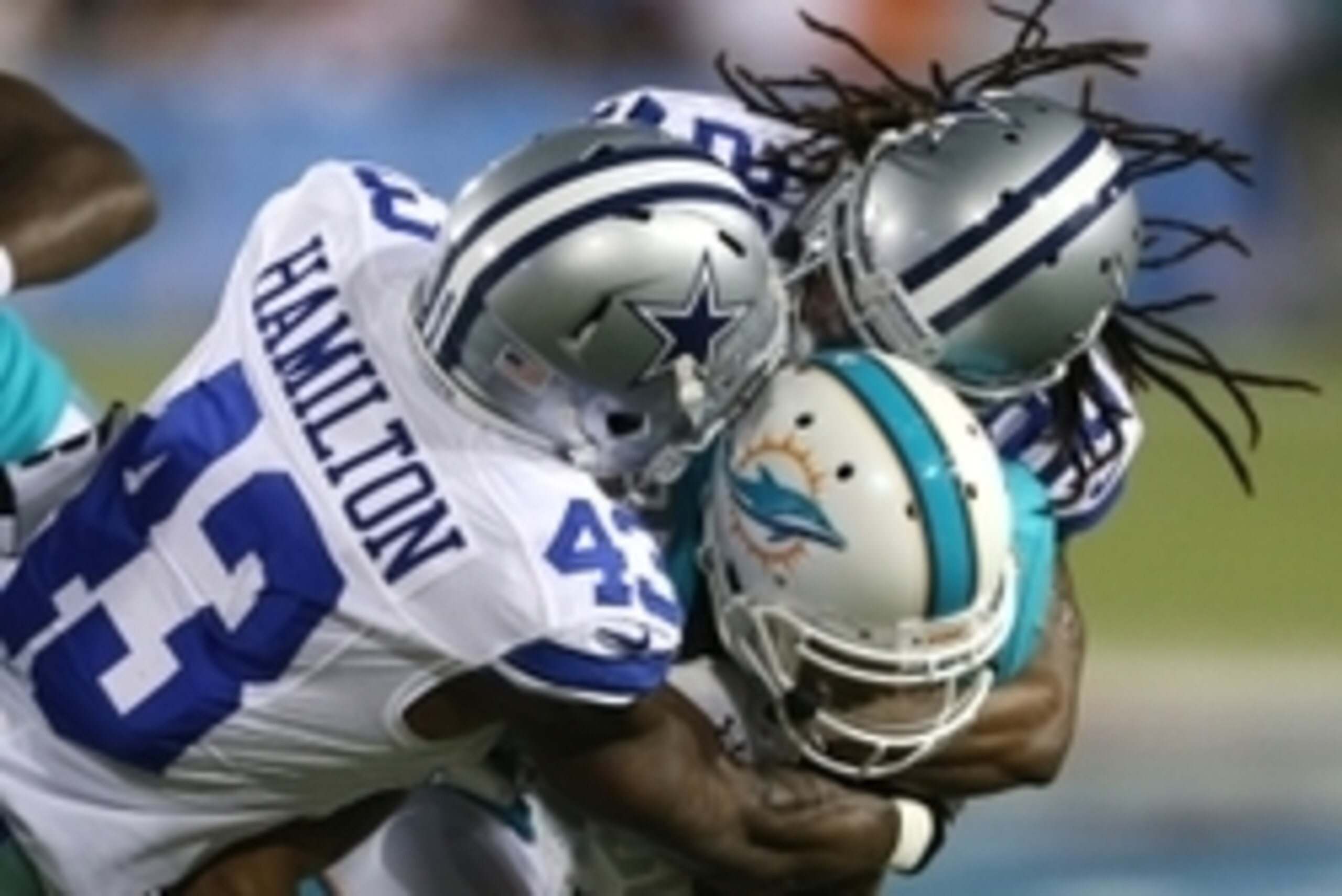 Aug 4, 2013; Canton, OH, USA; Miami Dolphins wide receiver Brian Tyms (85) is tackled by Dallas Cowboys defensive back Jakar Hamilton (43) and cornerback B.W. Webb (20) during the second quarter at Fawcett Stadium. Mandatory Credit: Ron Schwane-USA TODAY 