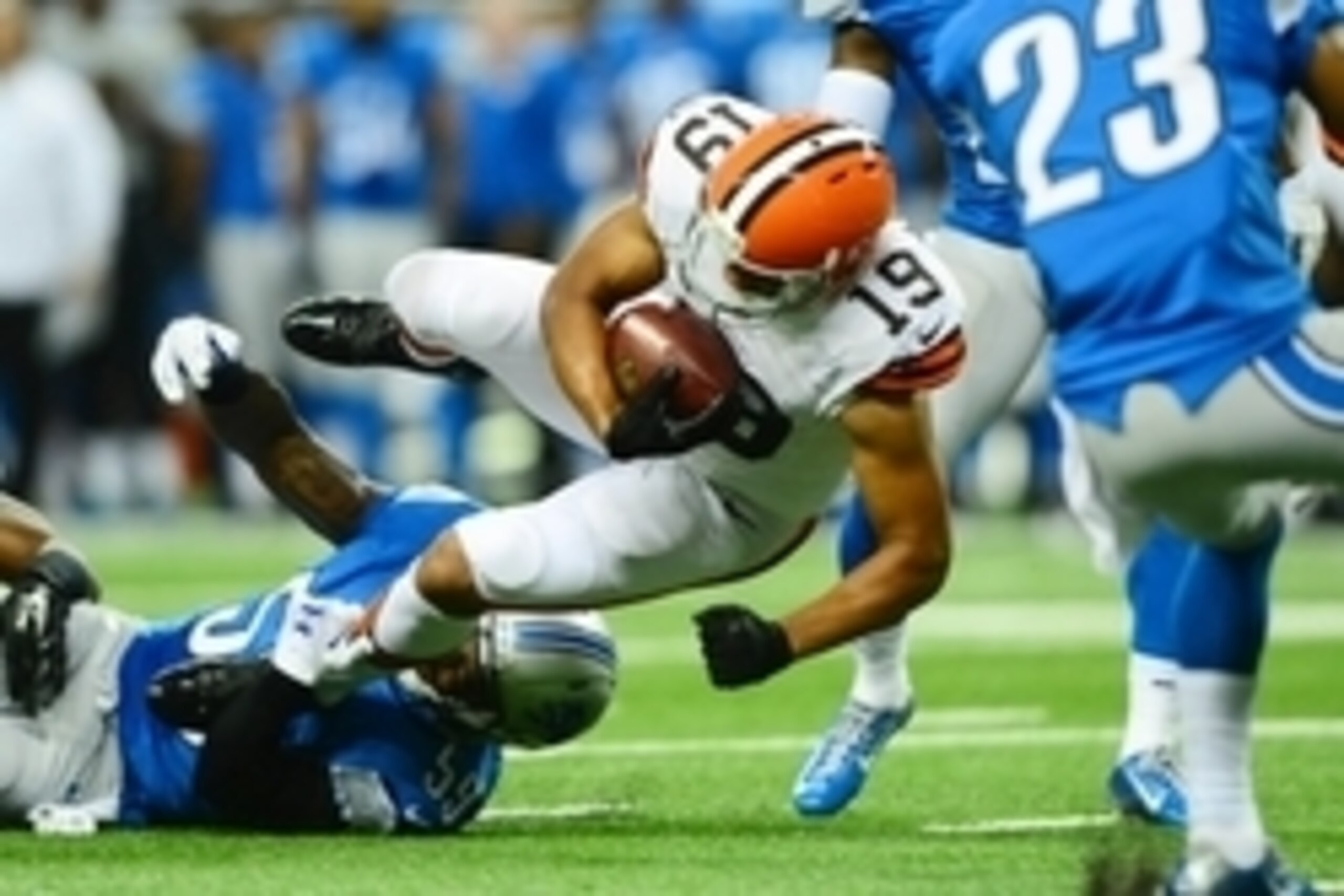 Aug 9, 2014; Detroit, MI, USA; Cleveland Browns wide receiver Miles Austin (19) is tripped up by Detroit Lions linebacker Tahir Whitehead (59) after making a catch during the second quarter at Ford Field. Mandatory Credit: Andrew Weber-USA TODAY Sports