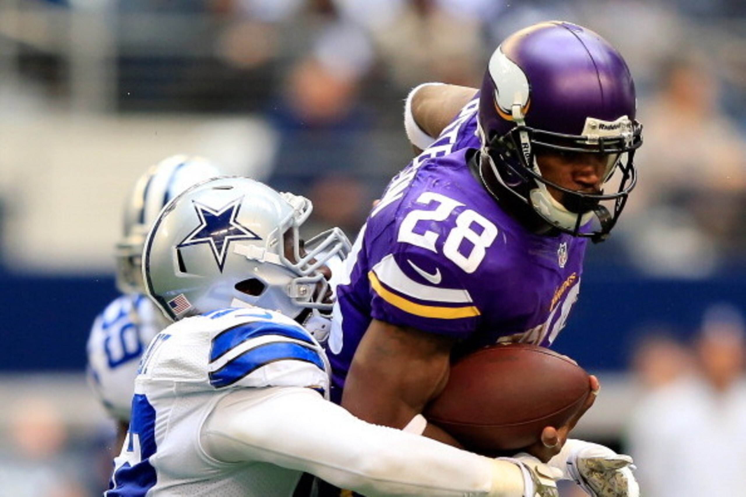 ARLINGTON, TX - NOVEMBER 03:  Running back Adrian Peterson #28 of the Minnesota Vikings carries the ball as outside linebacker Justin Durant #52 of the Dallas Cowboys defends during the game at Cowboys Stadium on November 3, 2013 in Arlington, Texas.  (Ph